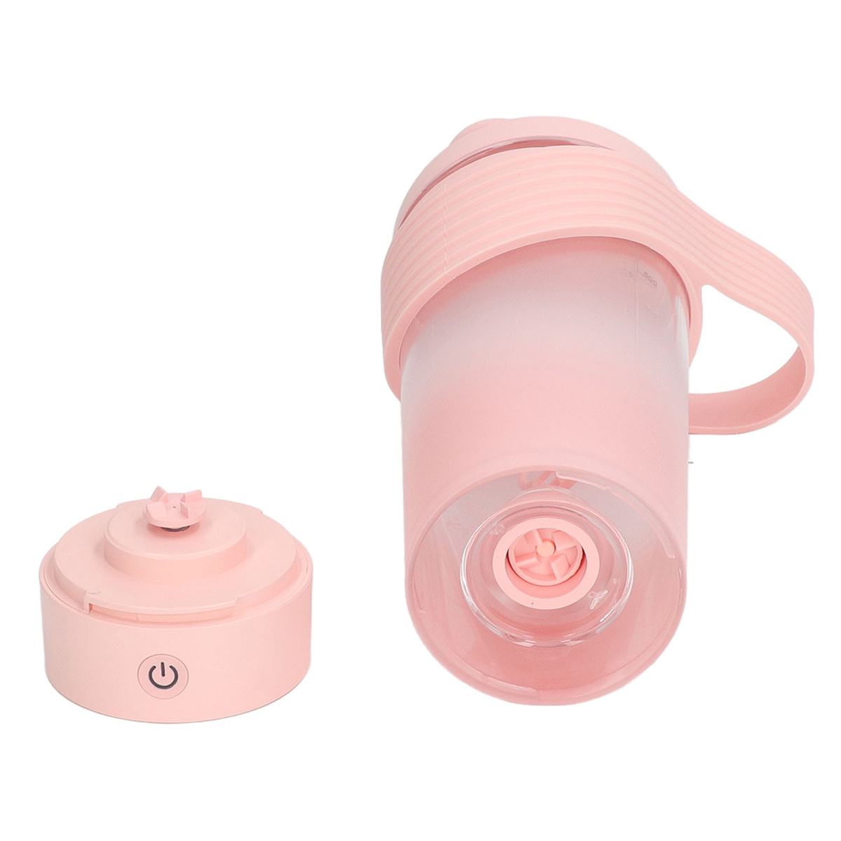 Ein pinkfarbener tragbarer Mixer mit abgetrennter Basis und Deckel, vor weißem Hintergrund.