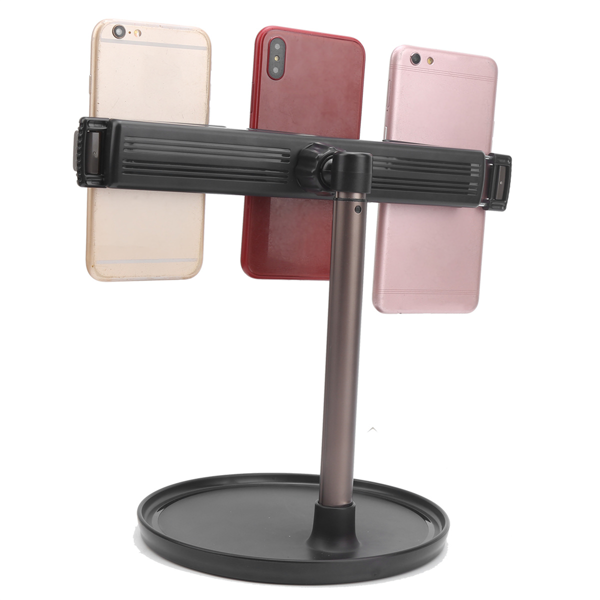 Ein Telefonständer mit drei befestigten Telefonen. Einmal gold, einmal rot und einmal rosa.