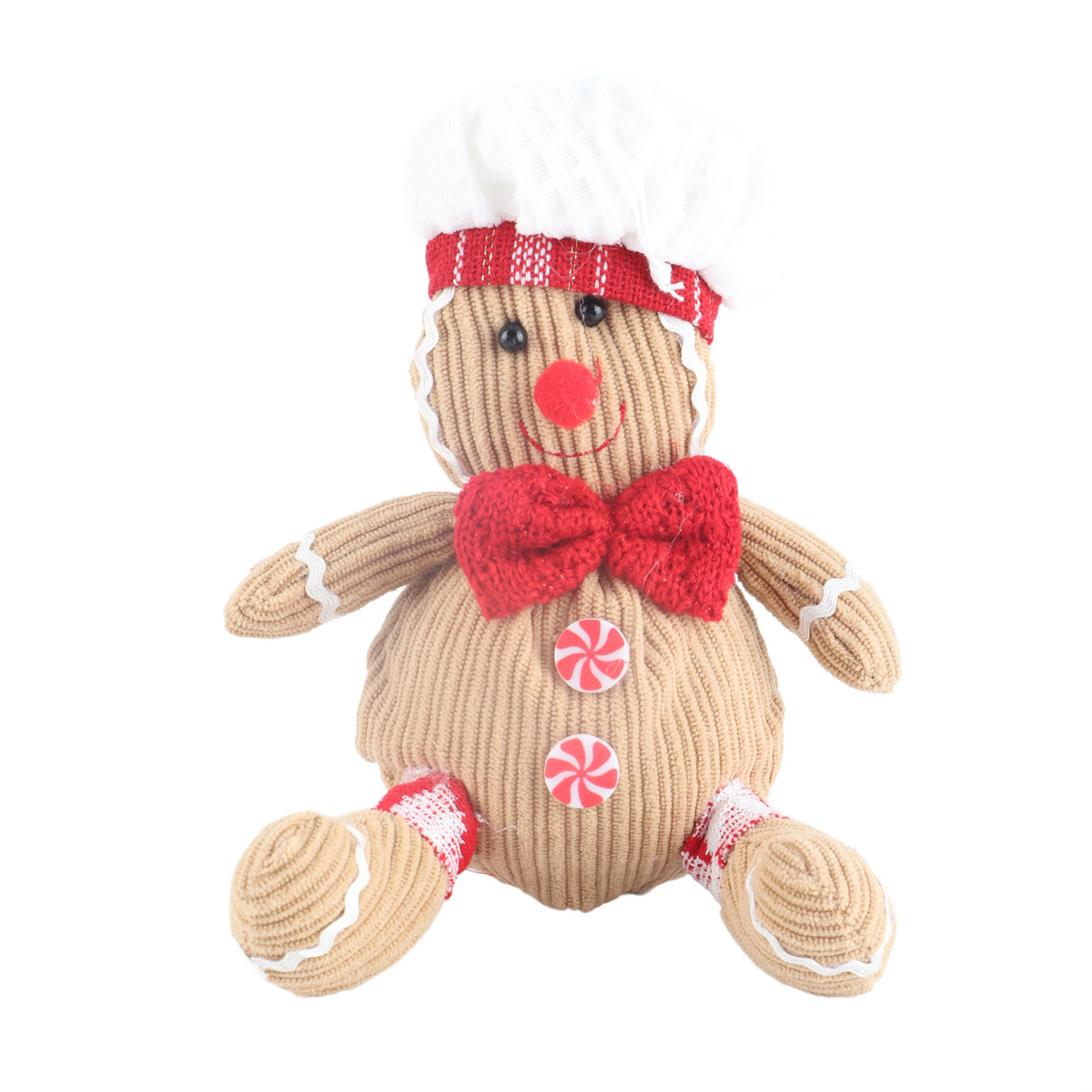 Eine gestrickte Lebkuchenmann-Figur mit Kochmütze, roter Fliege und Knopf-Bonbons auf weißem Hintergrund.