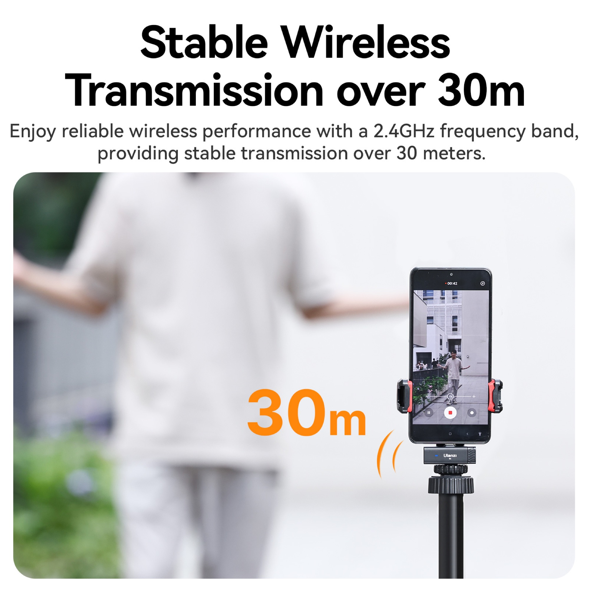 Person holding phone on a tripod, demonstrating wireless transmission over a distance of 30 meters.