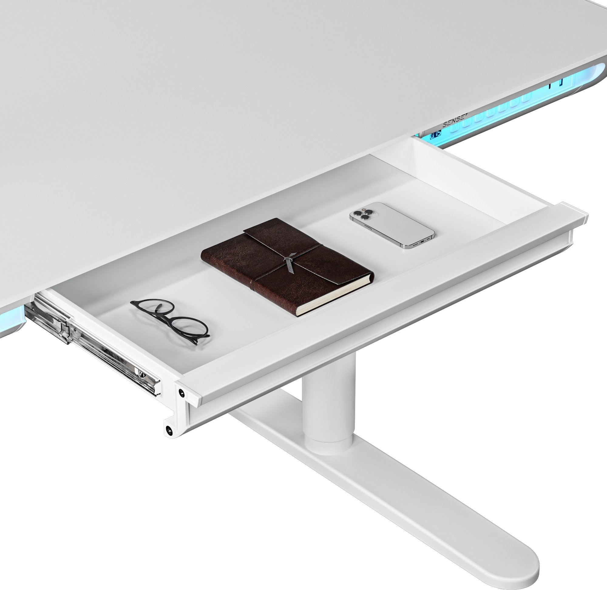 Een witte bureau met een open lade, met een notitieboek, bril en telefoon.
