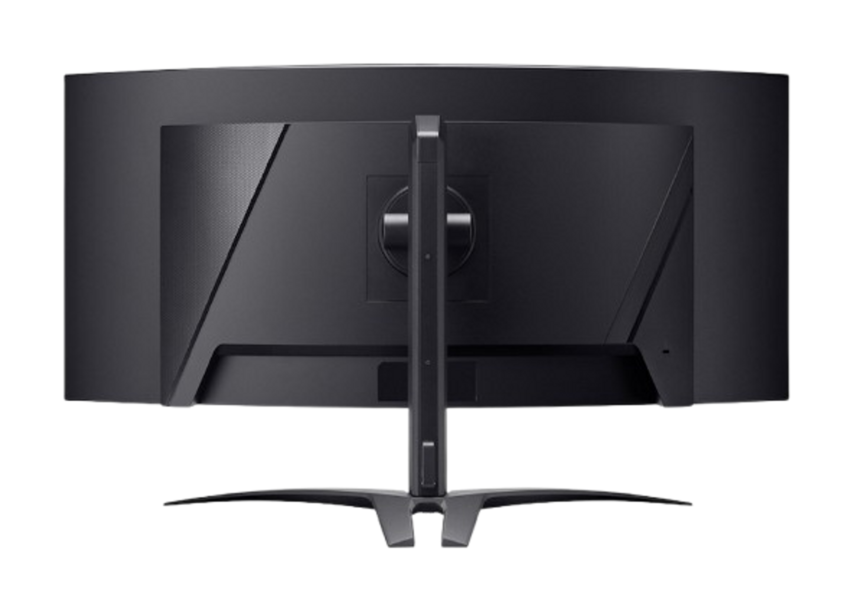 Zakrzywiony monitor. Tył jest ciemny ze stojakiem. Jest na czarnej powierzchni.