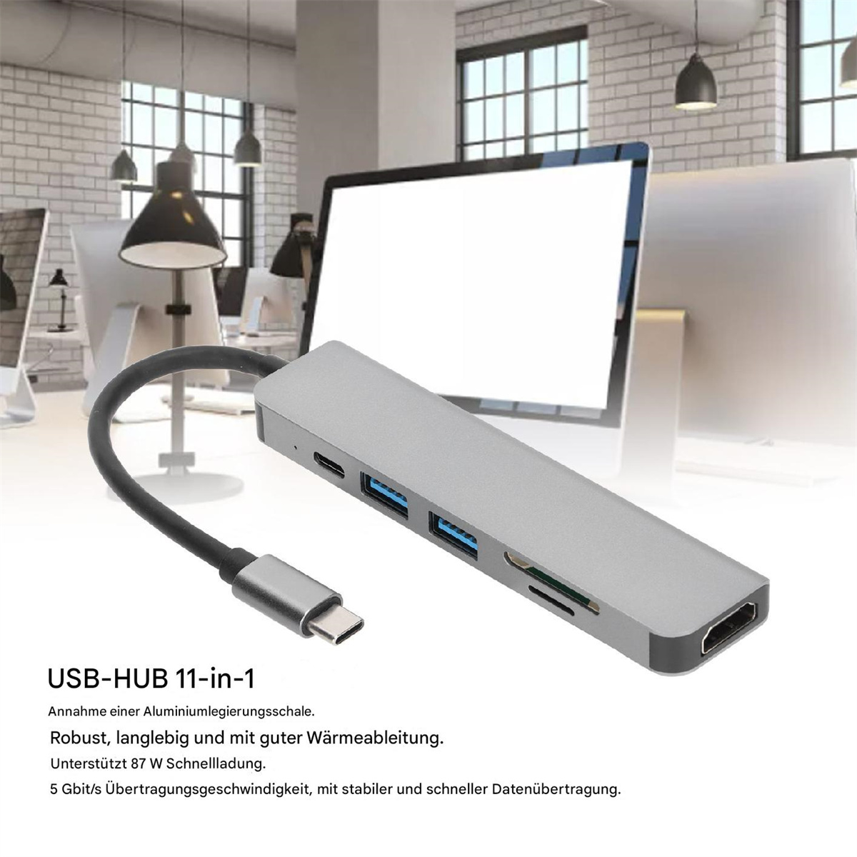 Ein silberner USB-Hub mit mehreren Anschlüssen und einem Monitor im Hintergrund.