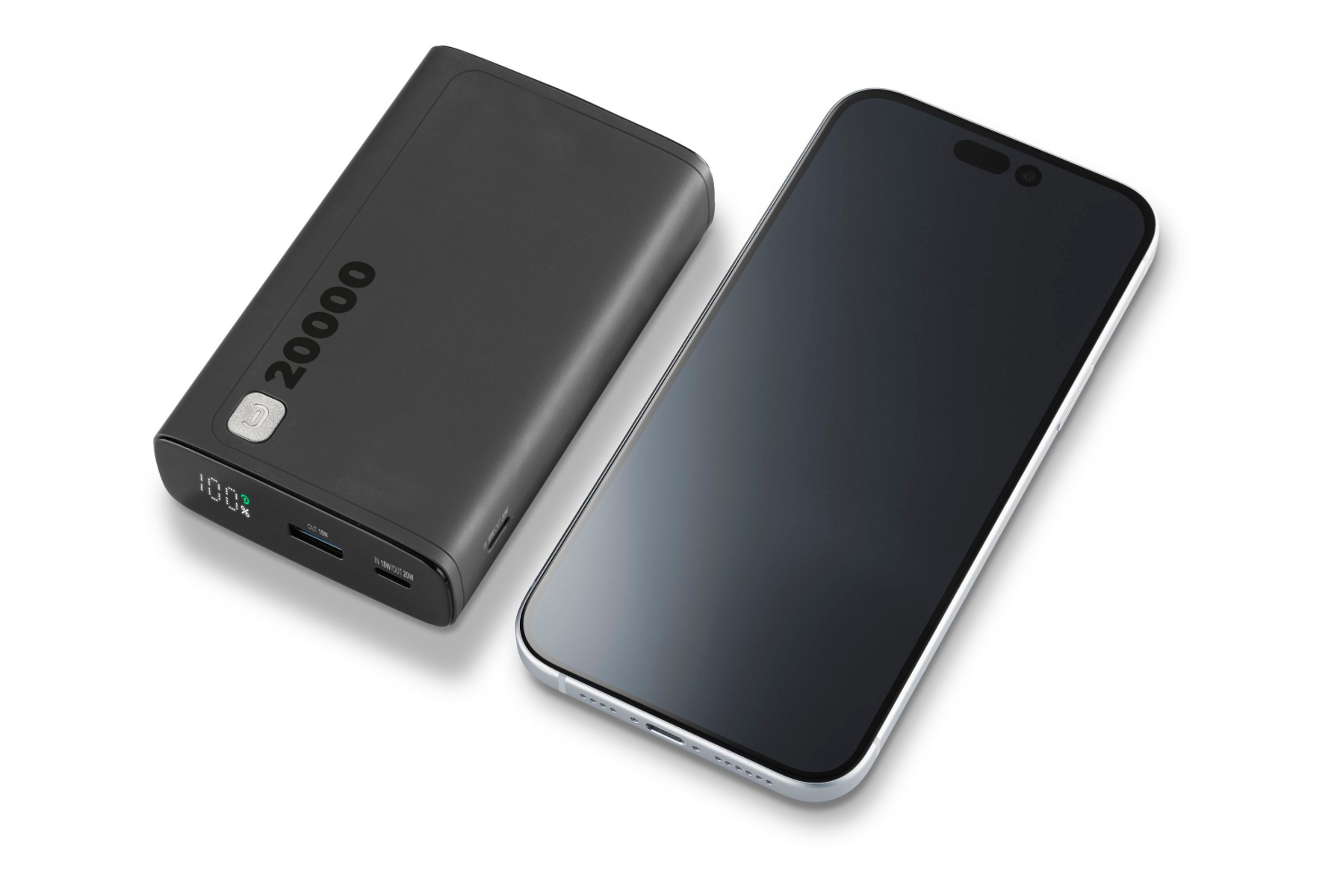 Czarny power bank obok smartfona. Power bank pokazuje 100% naładowania.