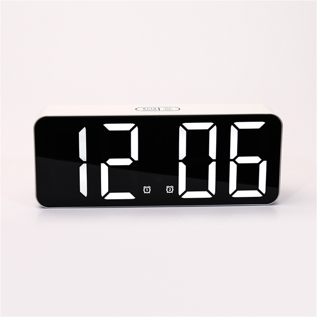 Ein digitaler weißer Wecker mit der Anzeige 12:06.