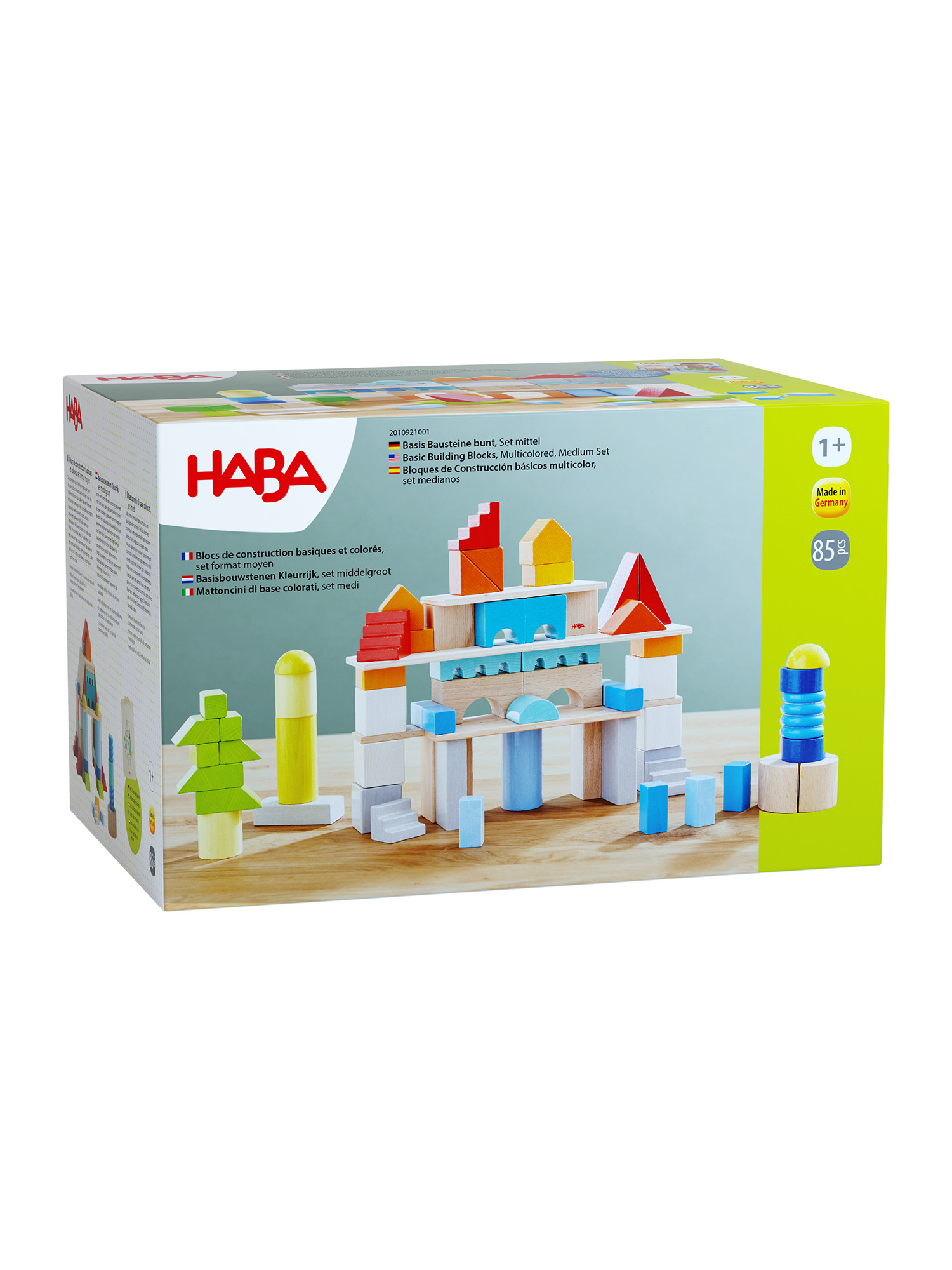 Kiste mit bunten Holzbausteinen, die wie Gebäude und Bäume angeordnet sind.
