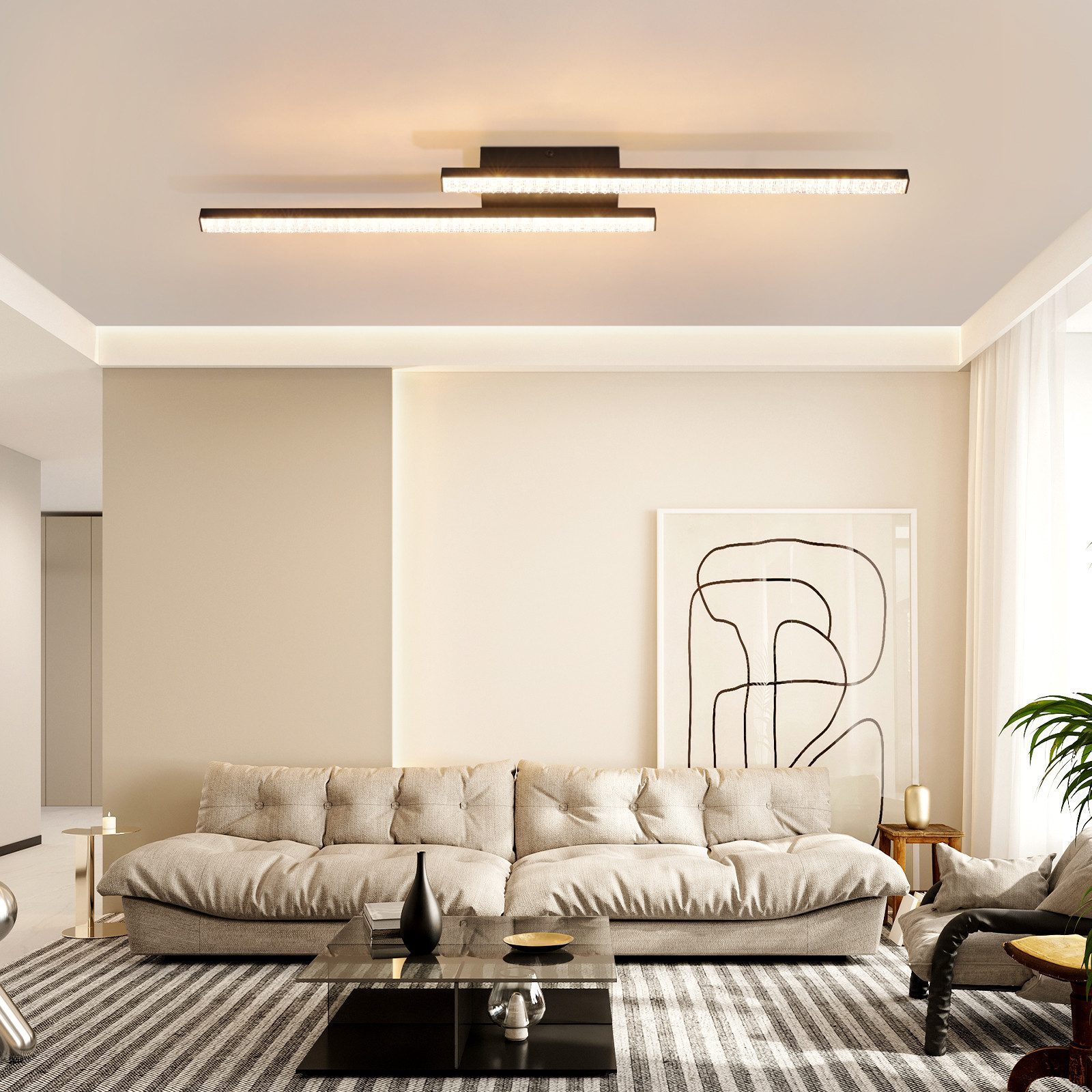 Salón moderno con sofá, mesa de centro y luz de techo. Las paredes son beige y hay un cuadro colgado.