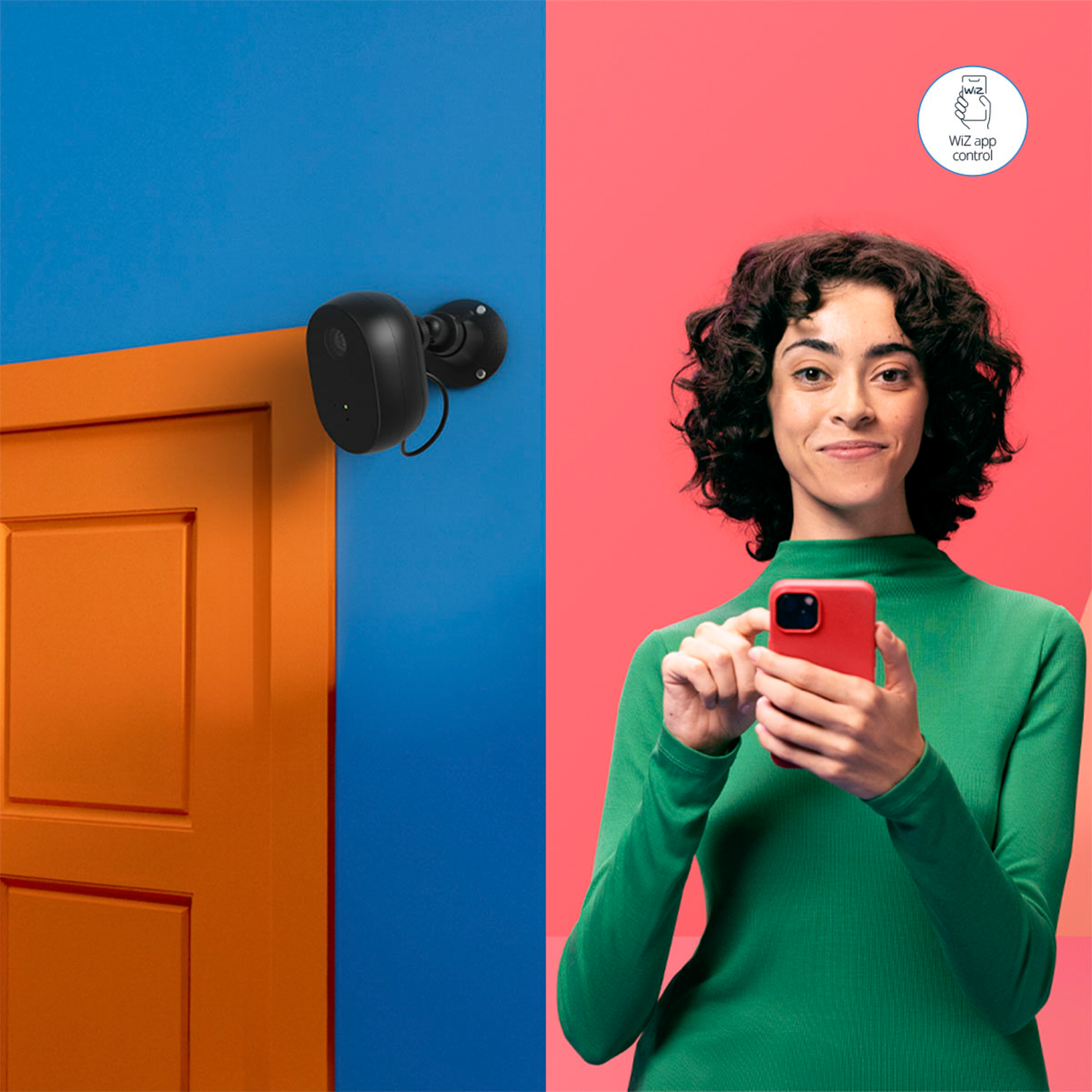 Woman holding a red phone, near a security camera.