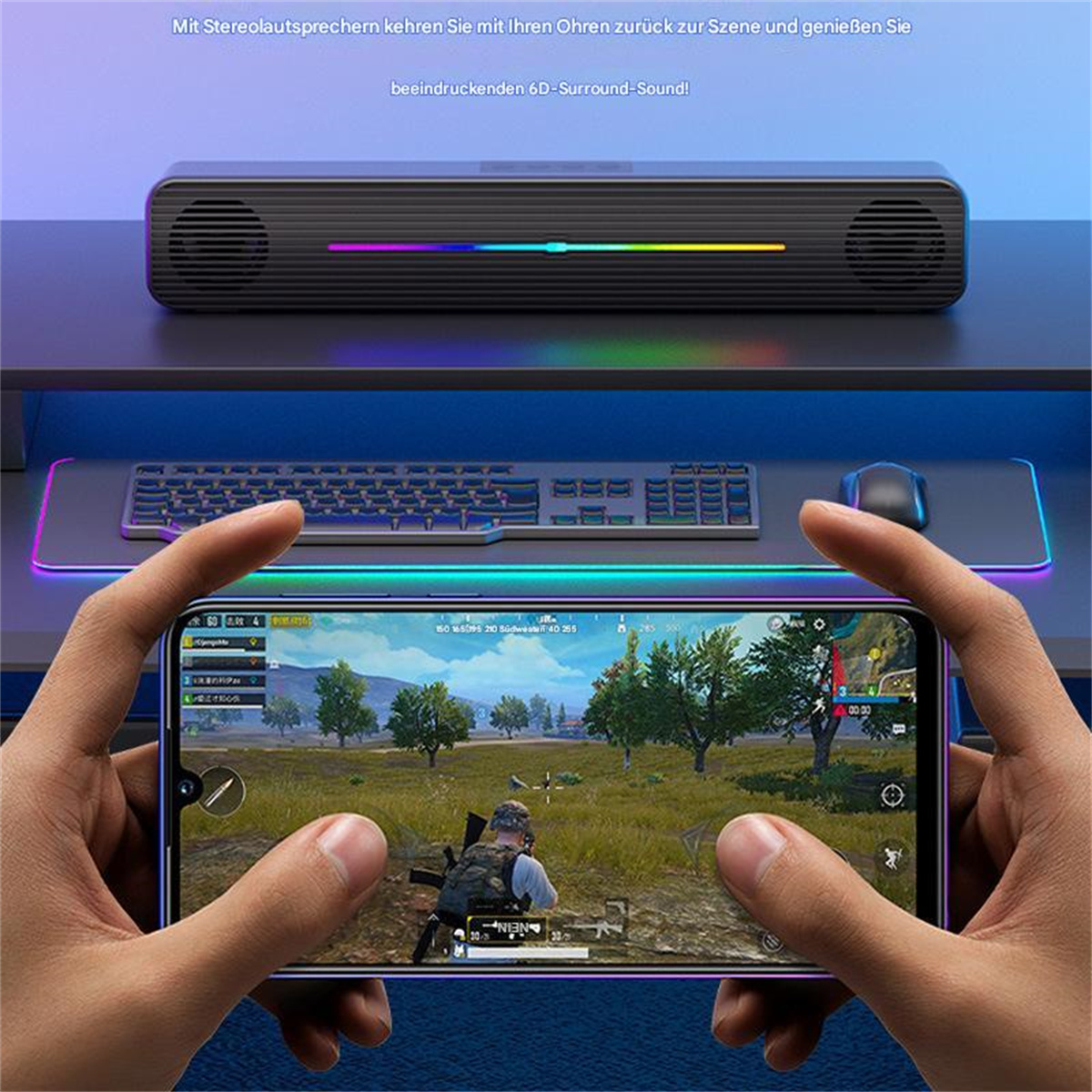 Person hält Telefon mit Spiel, Lautsprecher oben, Tastatur und Maus unten.