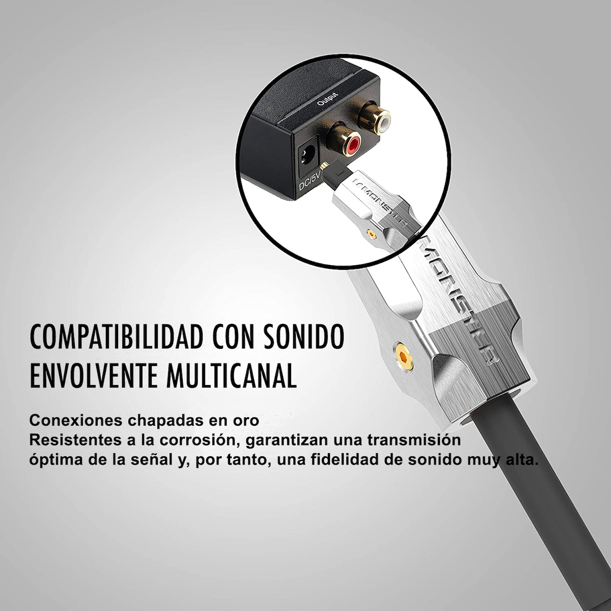 Un primo piano di un cavo audio con connettori placcati in oro, etichettato 'MONSTER' e 'Output'.