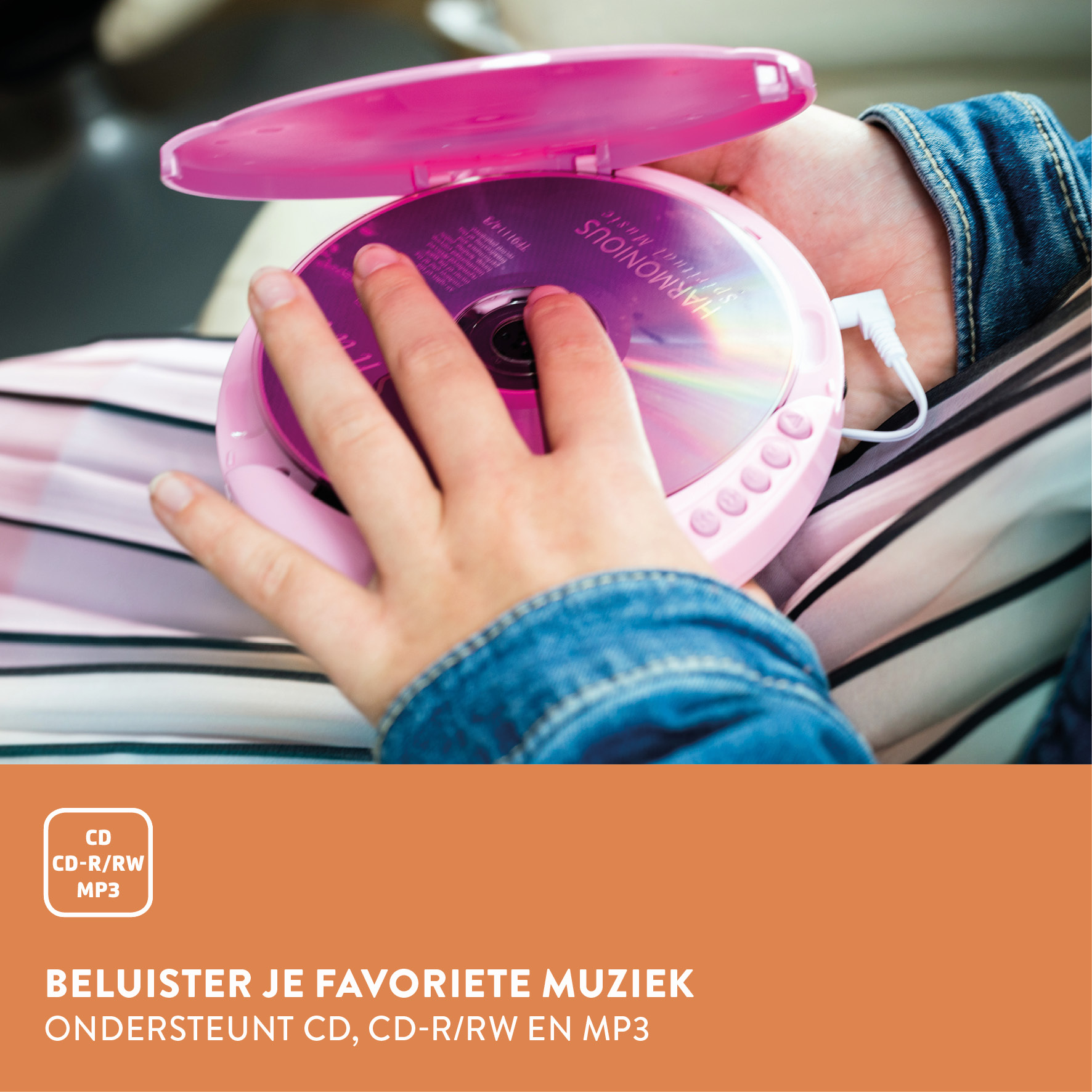 Een hand houdt een roze cd-speler met open deksel vast, een cd erin.