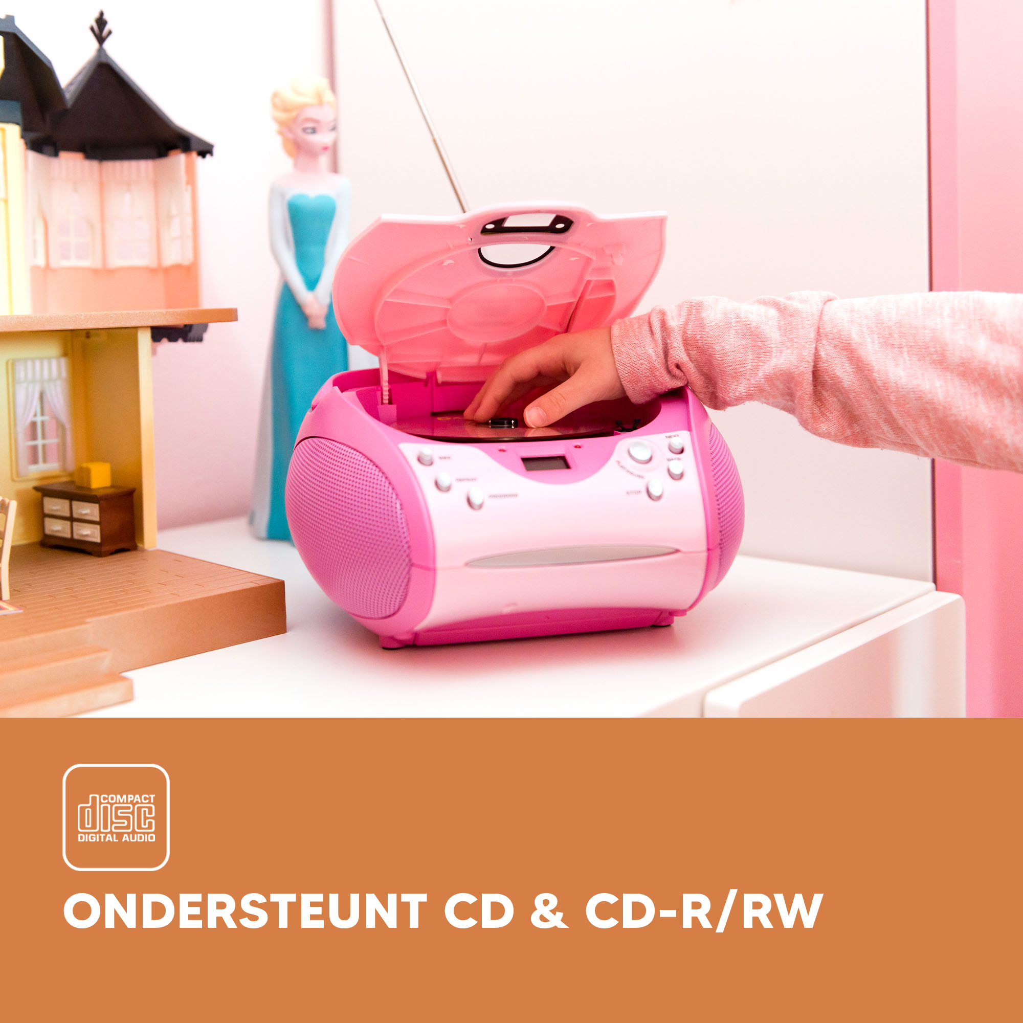 A child's hand inserting a CD into a pink boombox.