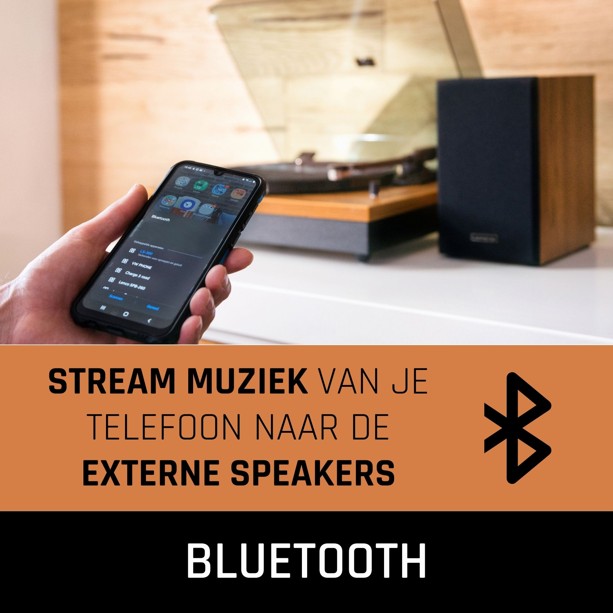 Hand holding phone showing music app. Turntable and speaker in background, with Bluetooth logo.