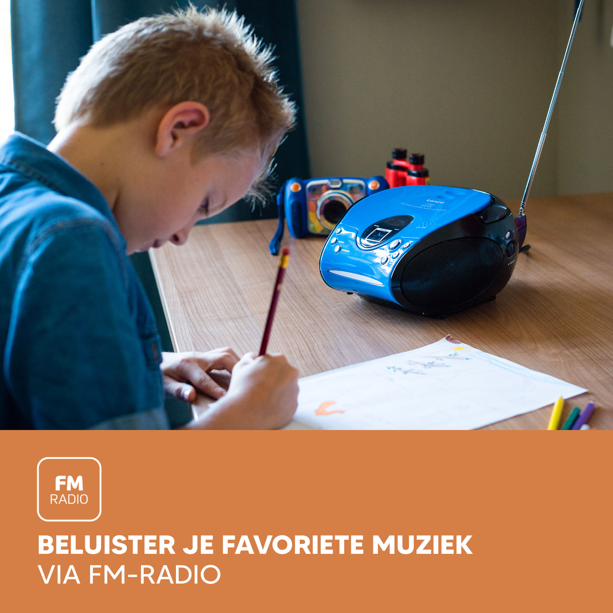 A child drawing at a table with a blue radio in the background, suggesting listening to FM radio.