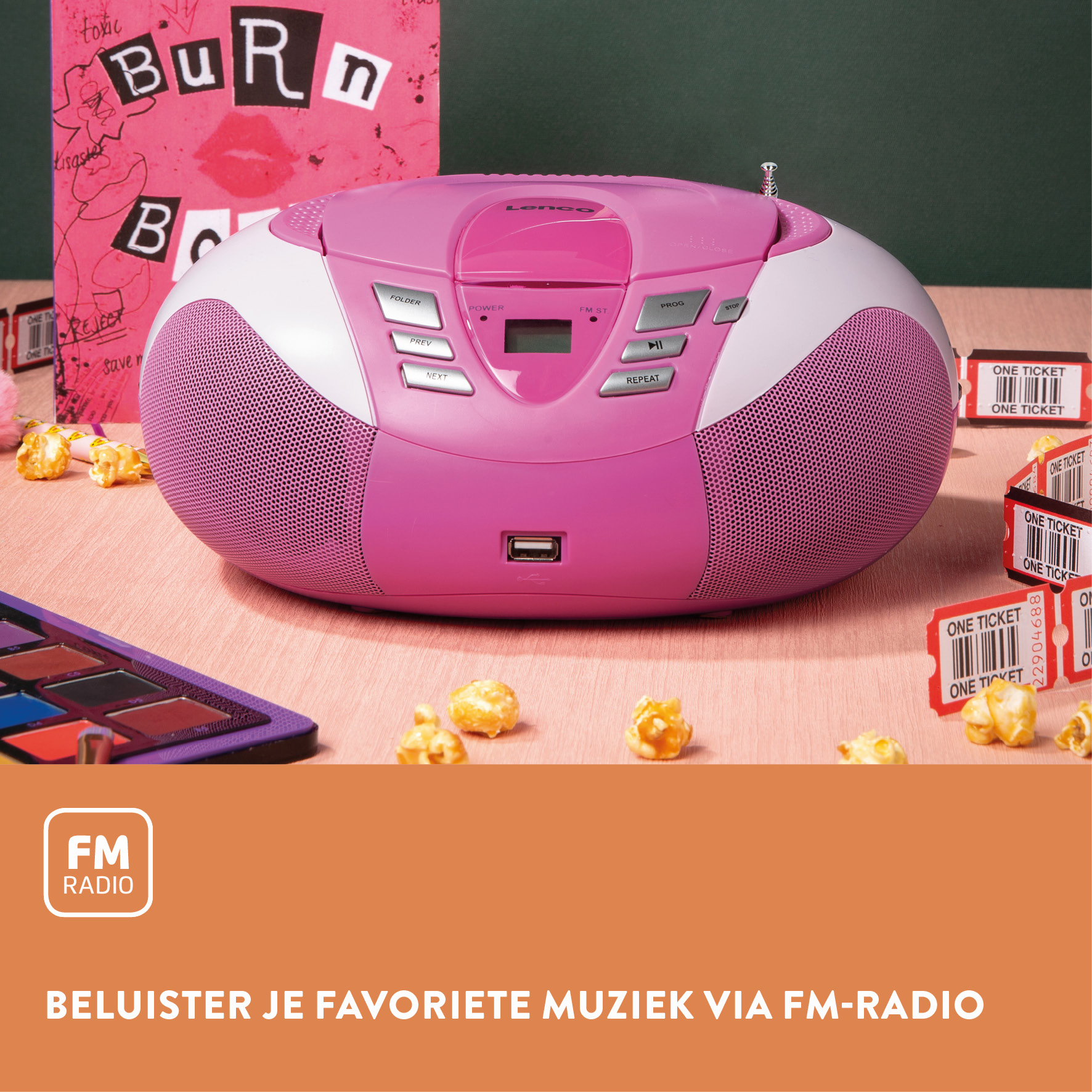 A pink and white radio CD player with a CD player, buttons, and a USB port. Popcorn and tickets are scattered.