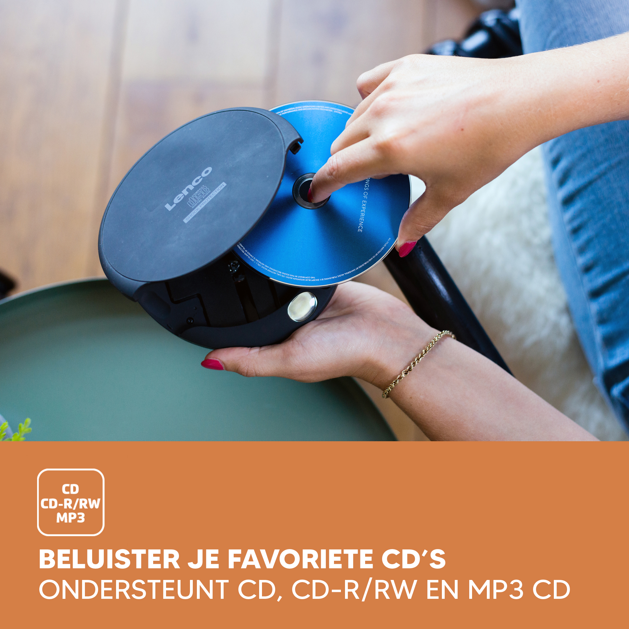 Hands inserting a CD into a CD player, with a blue CD.