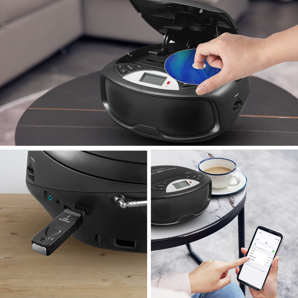 Schwarzer CD-Player mit einer Hand, die eine CD einlegt, und andere Gegenstände auf dem Tisch.
