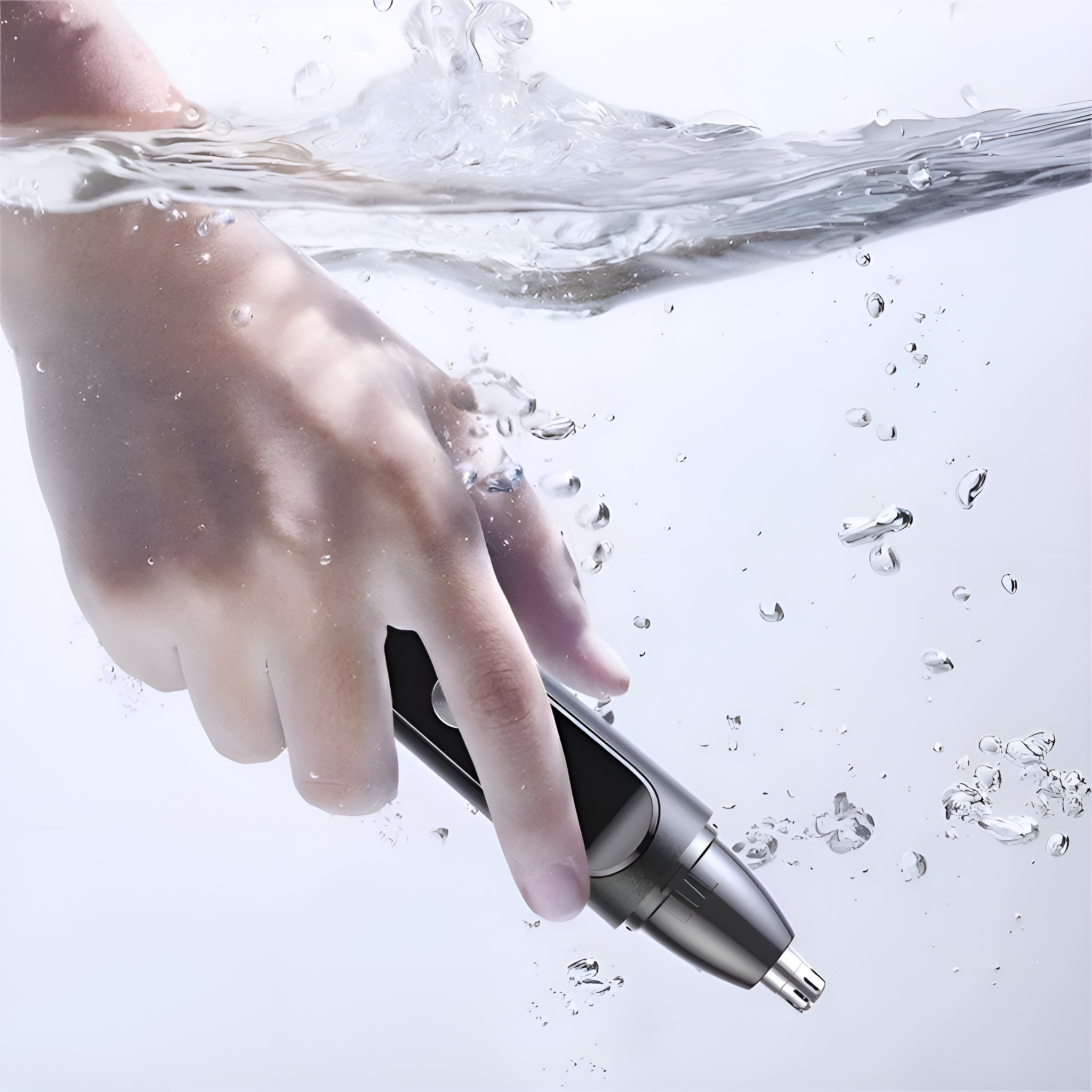 Hand, die einen Nasenhaartrimmer hält, der in Wasser getaucht ist, mit Blasen drumherum.