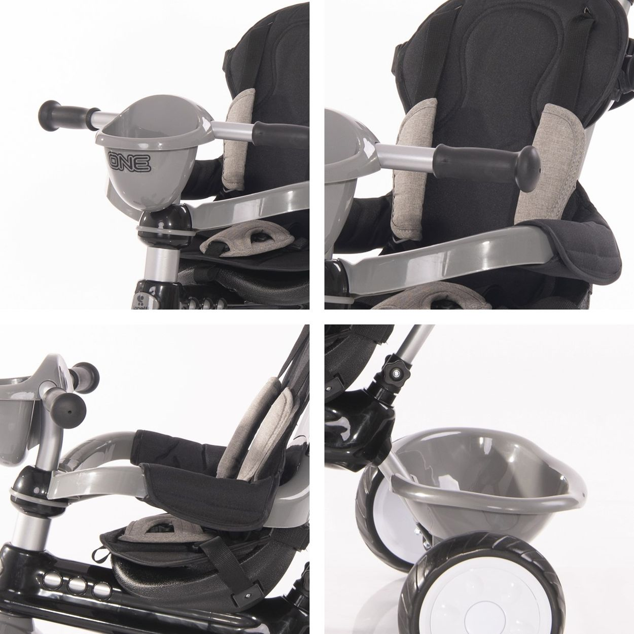 Nahaufnahme eines Kindertrikes. Das Dreirad ist grau und schwarz.