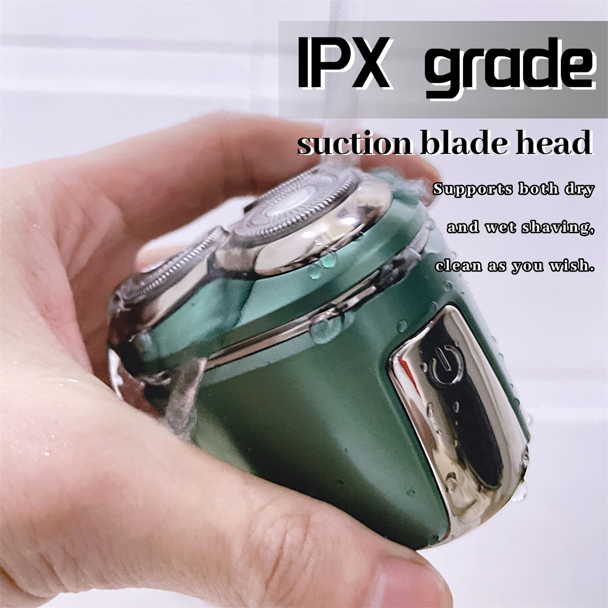 Grüner Elektrorasierer in der Hand. Text lautet "IPX grade" und "Suction blade head".