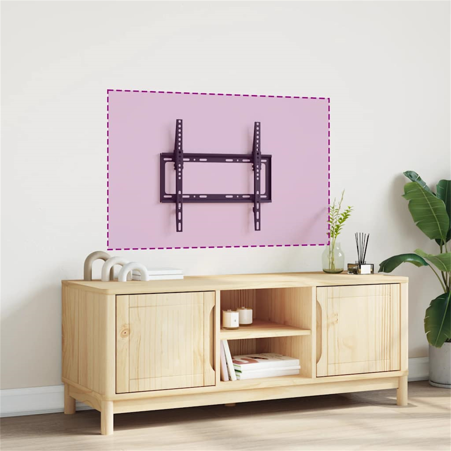 Fernseher an rosa Wand montiert, darunter Holzschrank. Pflanzen und Deko vorhanden.