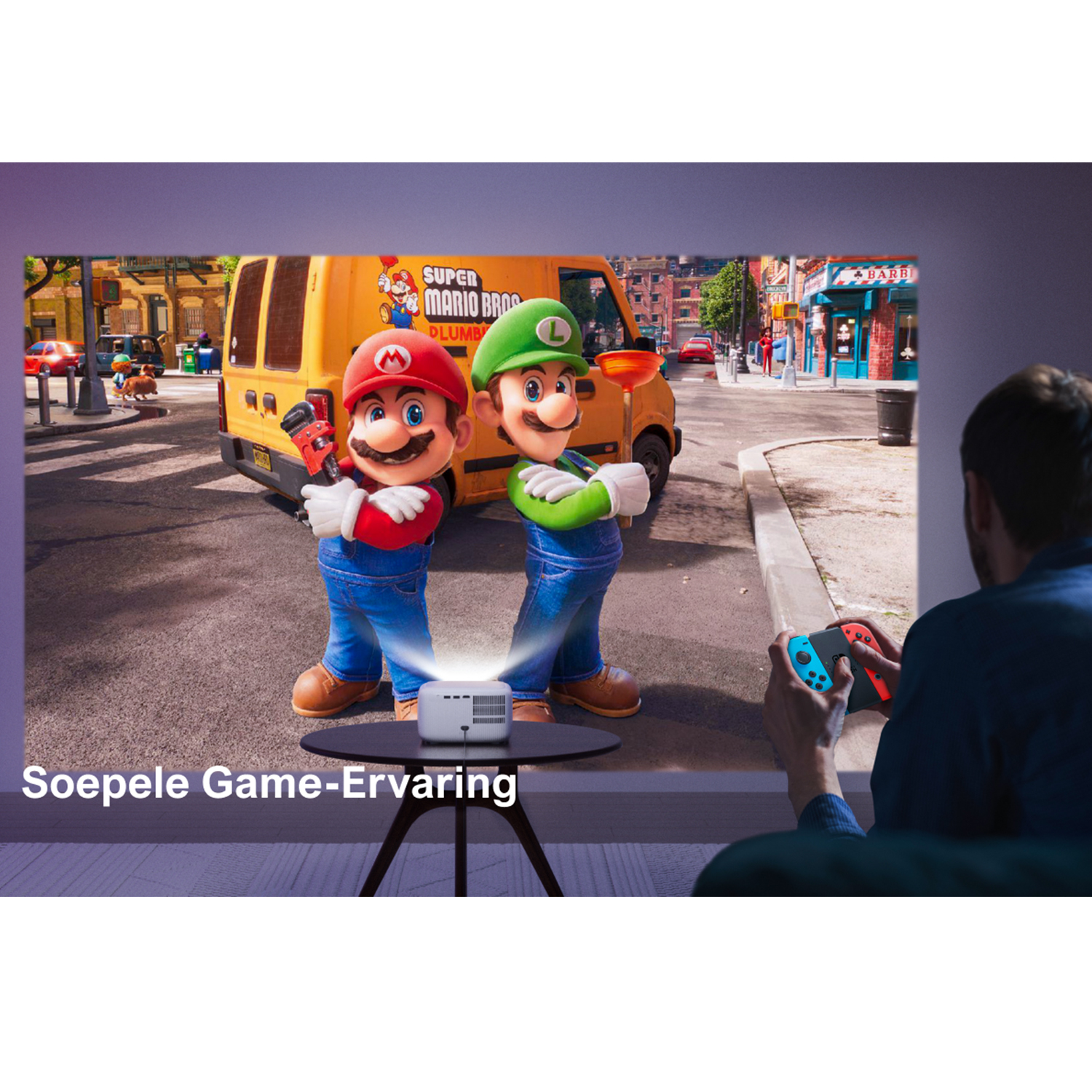 A projector projecting Mario Bros. on a screen, with a person playing games.