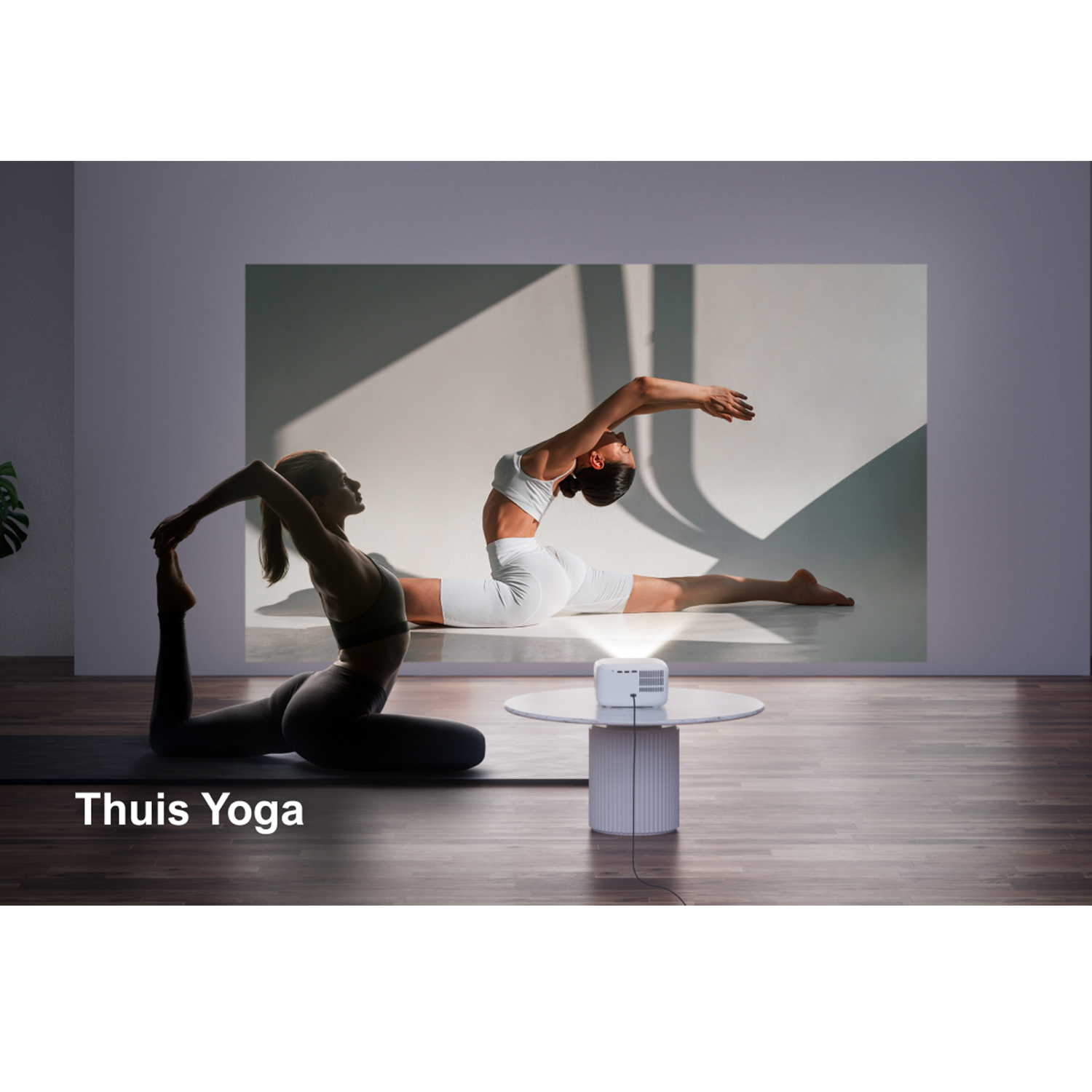 Yoga scene projected on wall, two women practicing yoga.