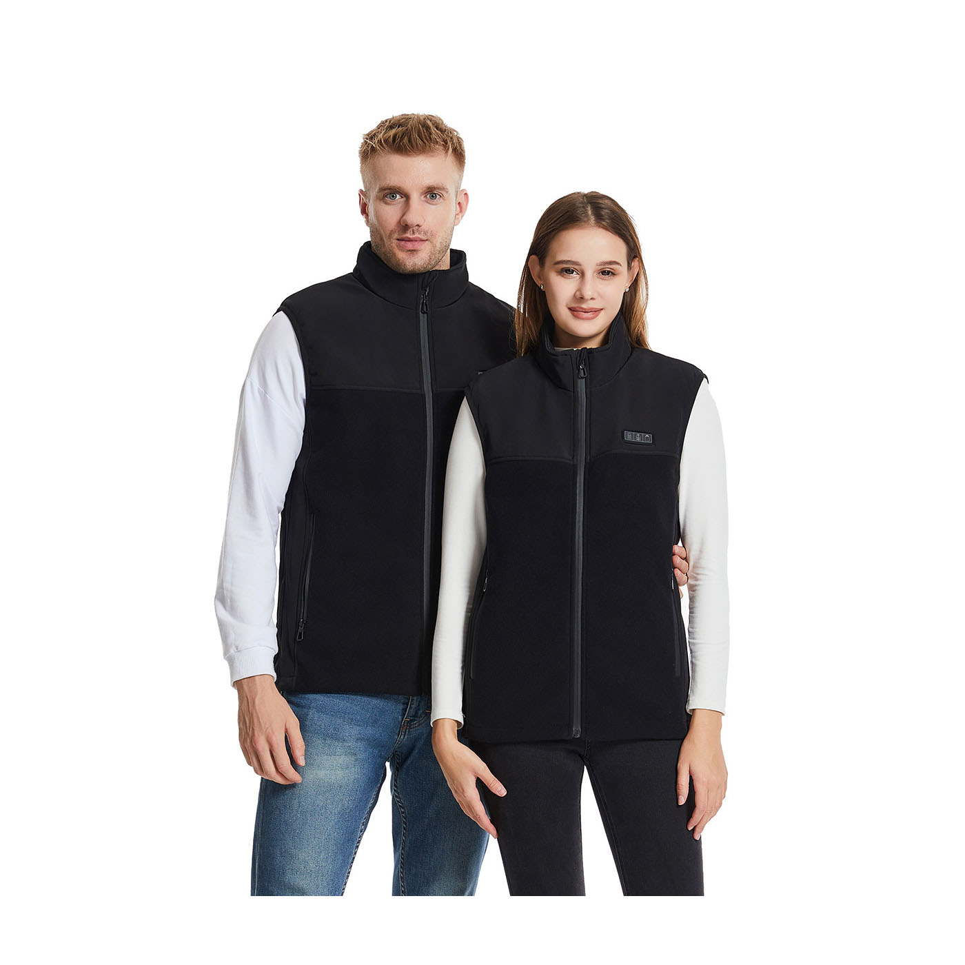 A man and a woman wearing black heated vests, standing side by side.