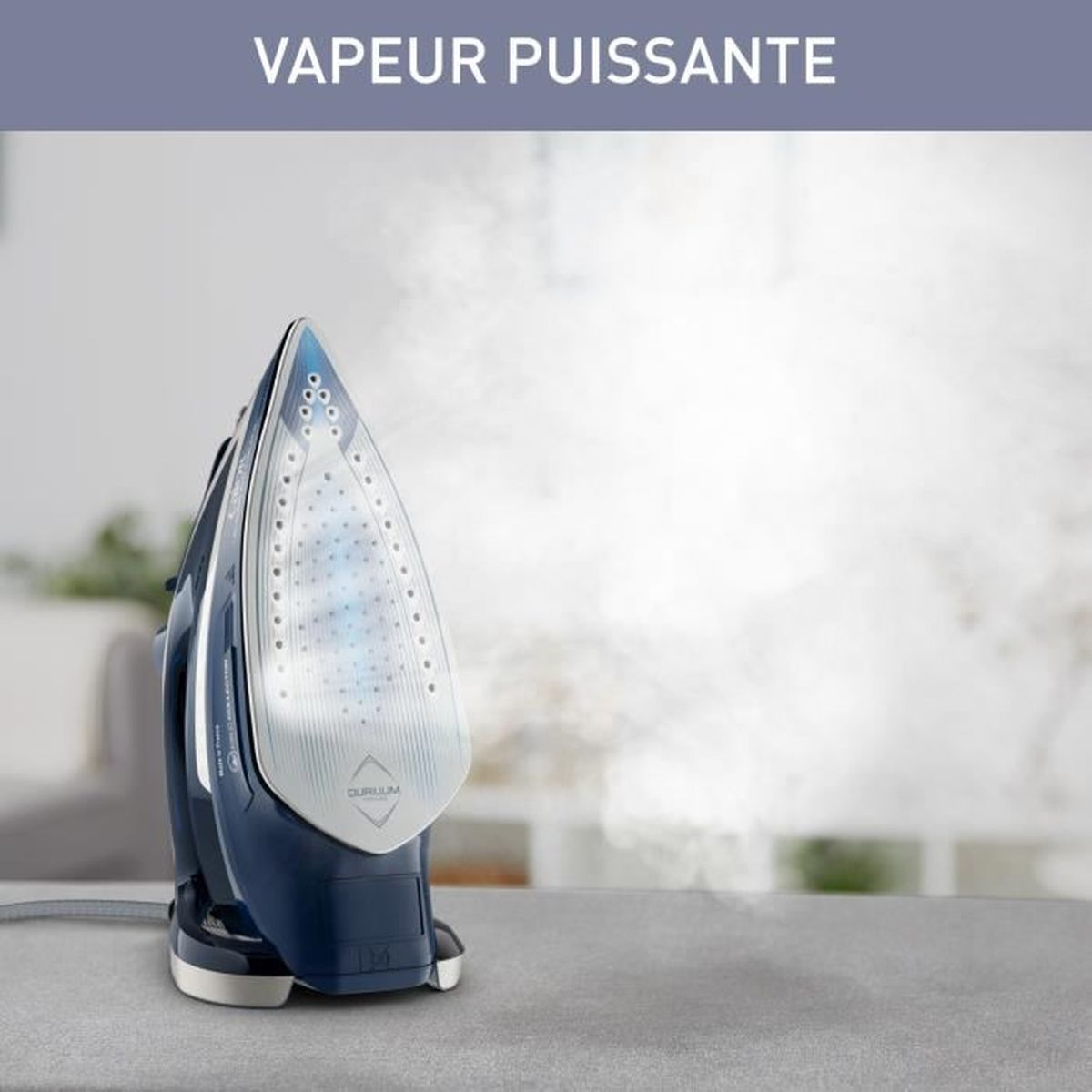 A blue iron steaming on a gray surface, with text 'VAPEUR PUISSANTE', suggesting powerful steam, in a bright setting.