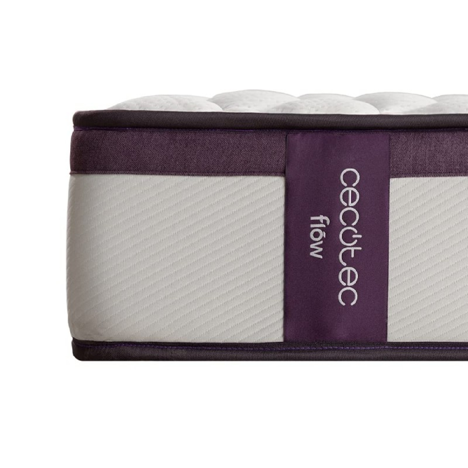 Primer plano del lado del colchón. Parte superior blanca, lado morado con etiqueta de marca. Colchón blanco y gris.