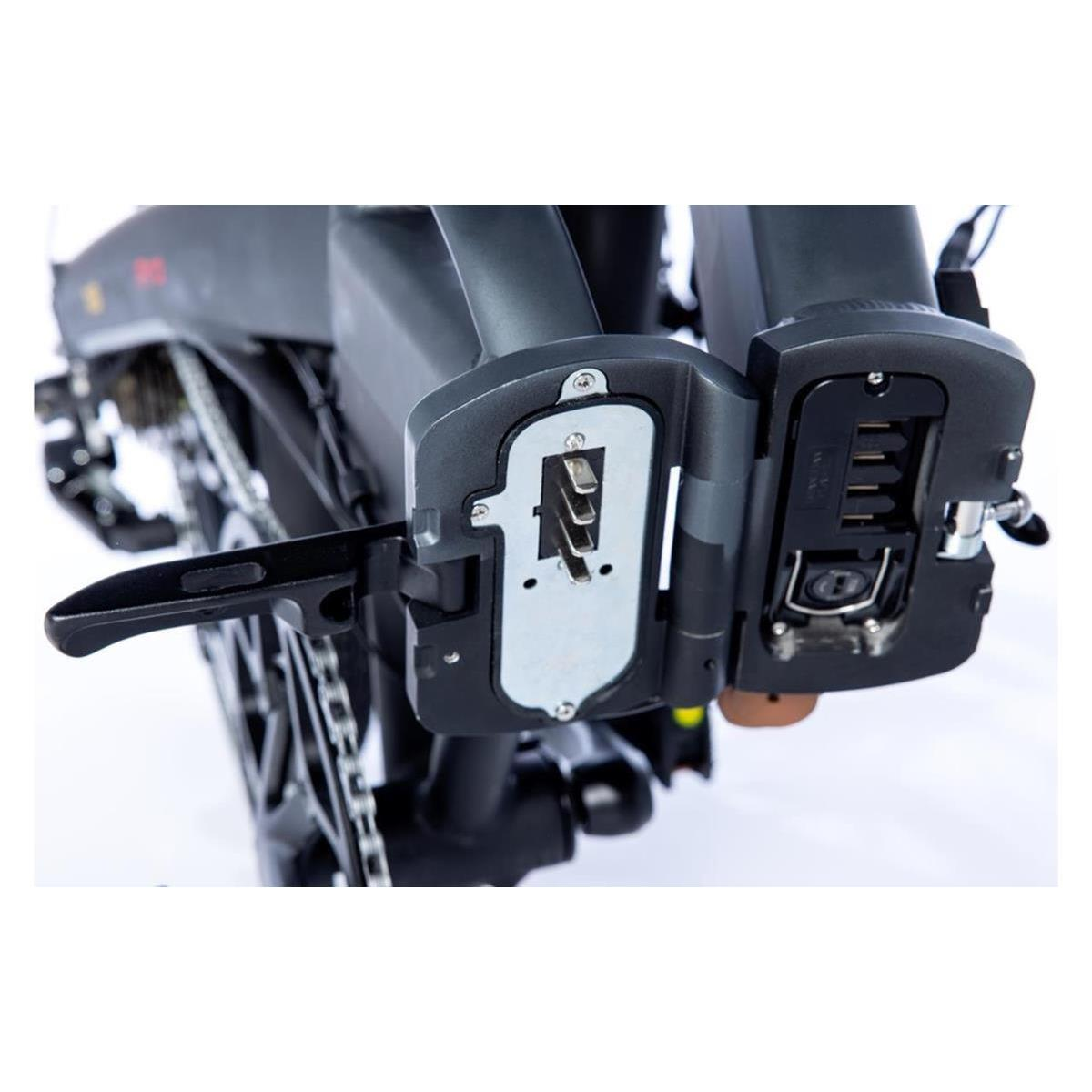 Primo piano della porta di ricarica di una bici elettrica. La porta è aperta, mostrando i contatti di ricarica.