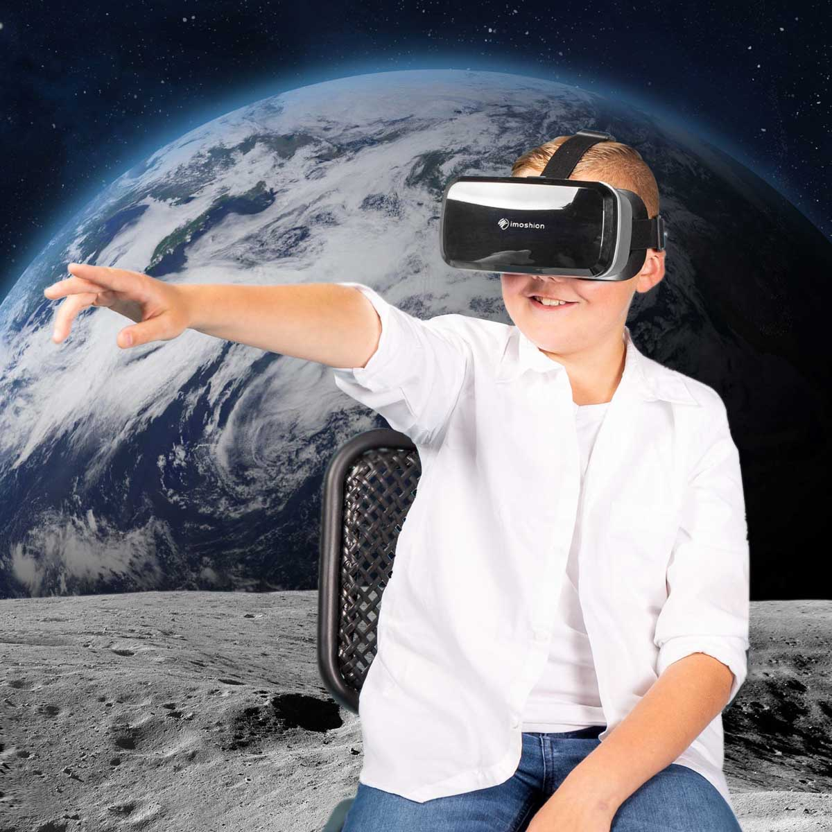 Boy wearing VR headset, reaching towards an earth and space background, on a lunar surface.