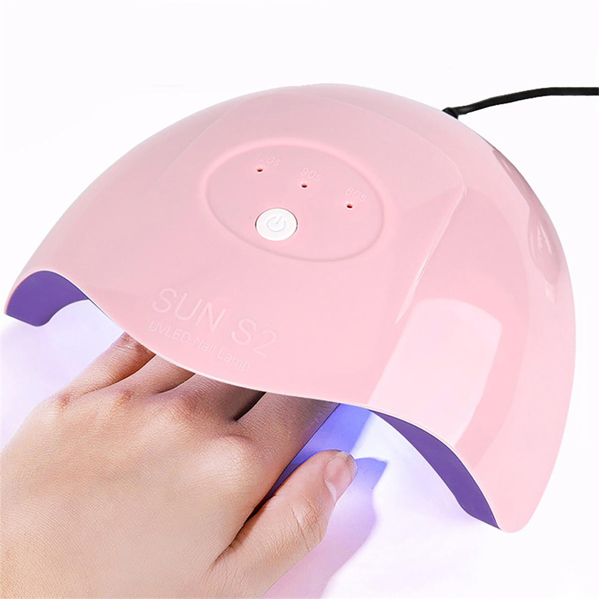 Eine rosa UV-Nagellampe mit einer Hand darin, die Knöpfe und Einstellungen der Lampe sind sichtbar.