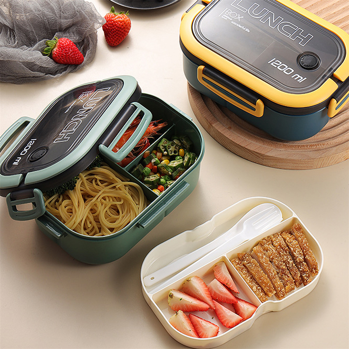 Eine Lunchbox mit Essen, darunter Nudeln, Gemüse, Erdbeeren und Frittiertes.