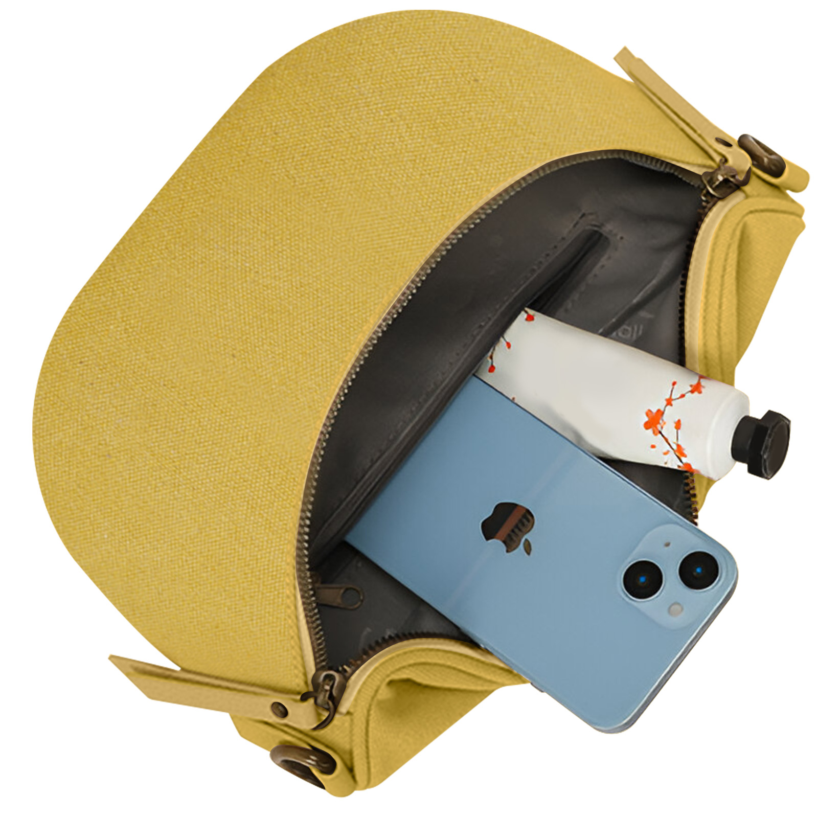 Bolso amarillo con teléfono y tubo de pintura dentro. Cremallera abierta, vista en ángulo.