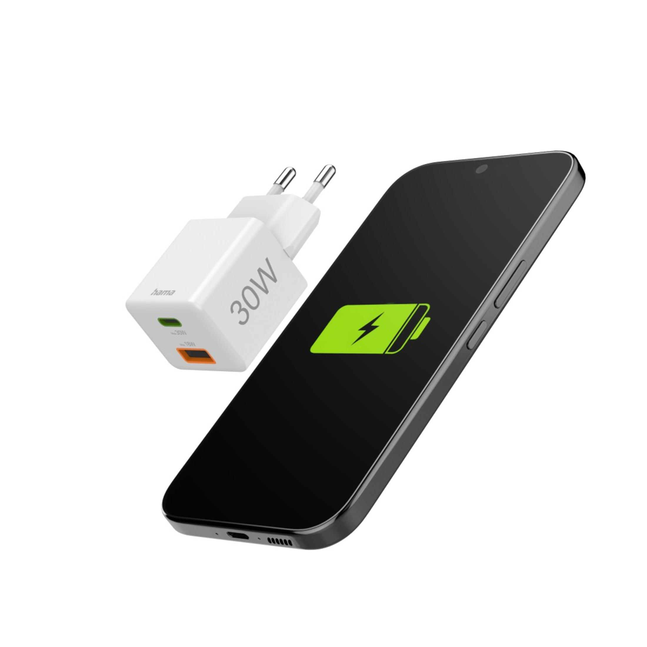 A white charger and a black phone with a green charging icon. The phone is angled.