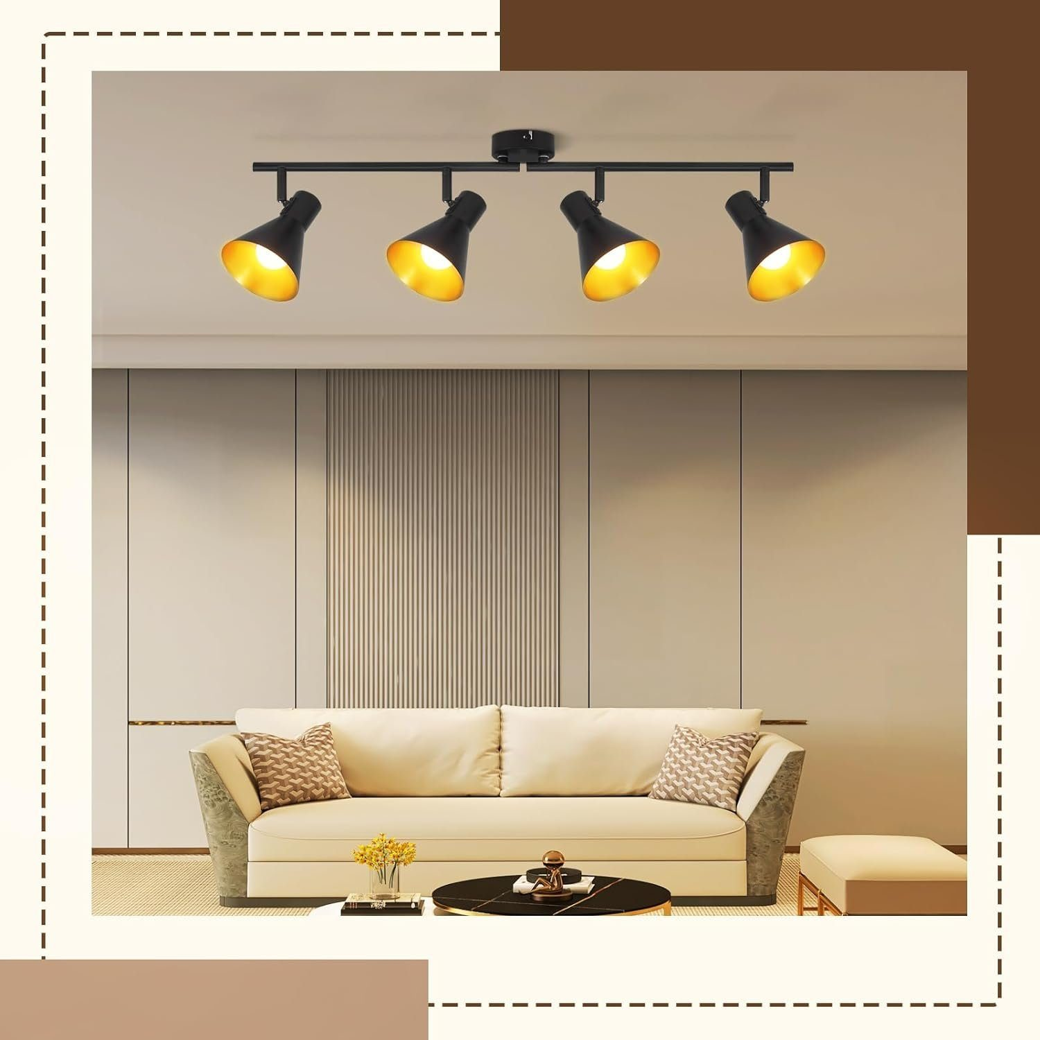 Cztery czarne reflektory ze złotymi wnętrzami, zamontowane na szynie, nad sofą.
