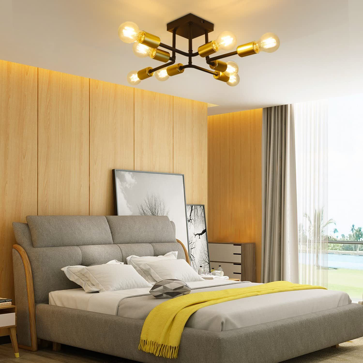 Sypialnia z łóżkiem i oprawą oświetleniową. Oprawa ma złote światła i ciemną ramę.