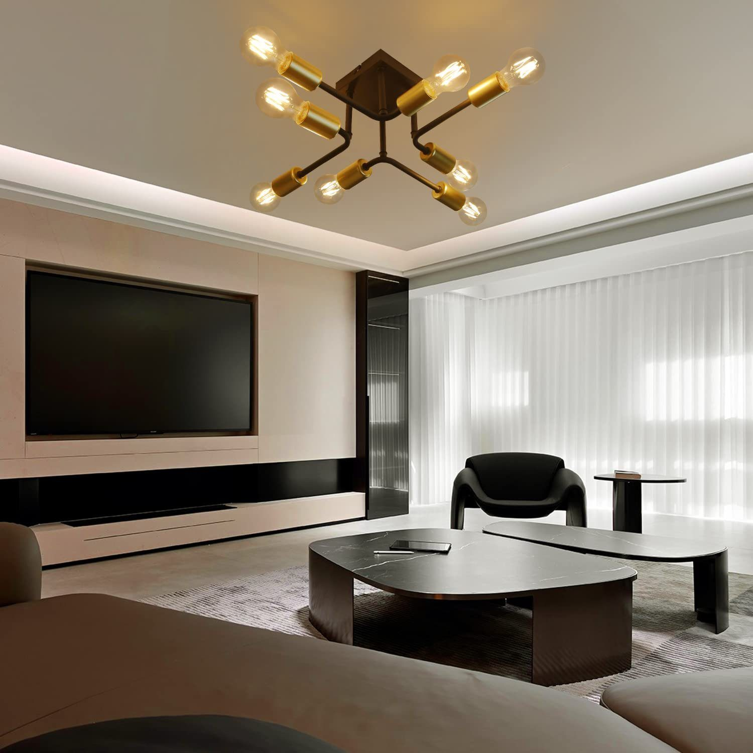 Nowoczesny salon. Czarne stoliki kawowe, telewizor, lampa sufitowa i sofa.