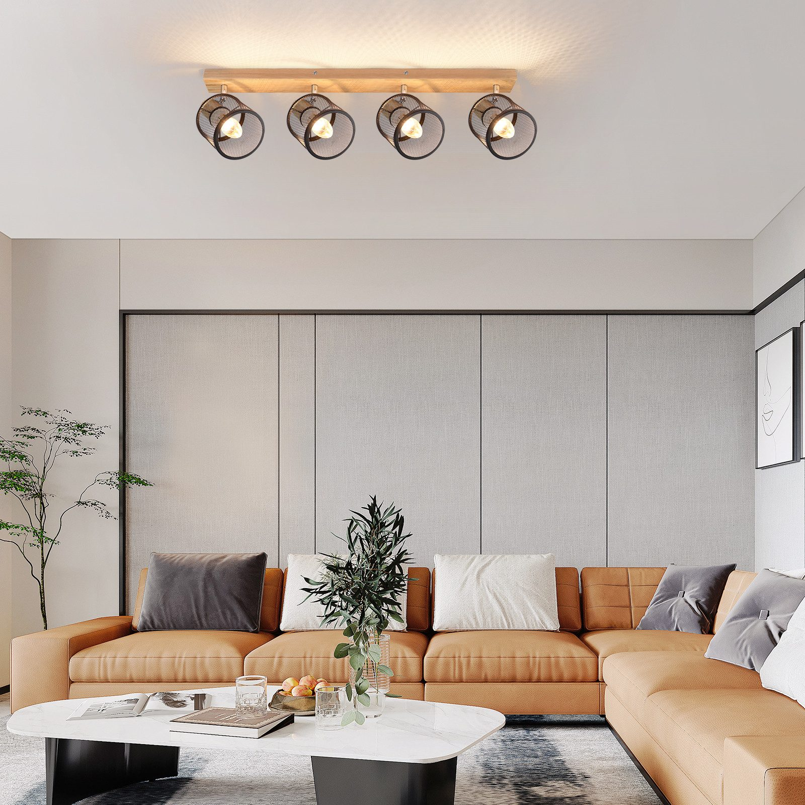 Lampa sufitowa z czterema światłami w czarnych metalowych klatkach, na drewnianej belce.