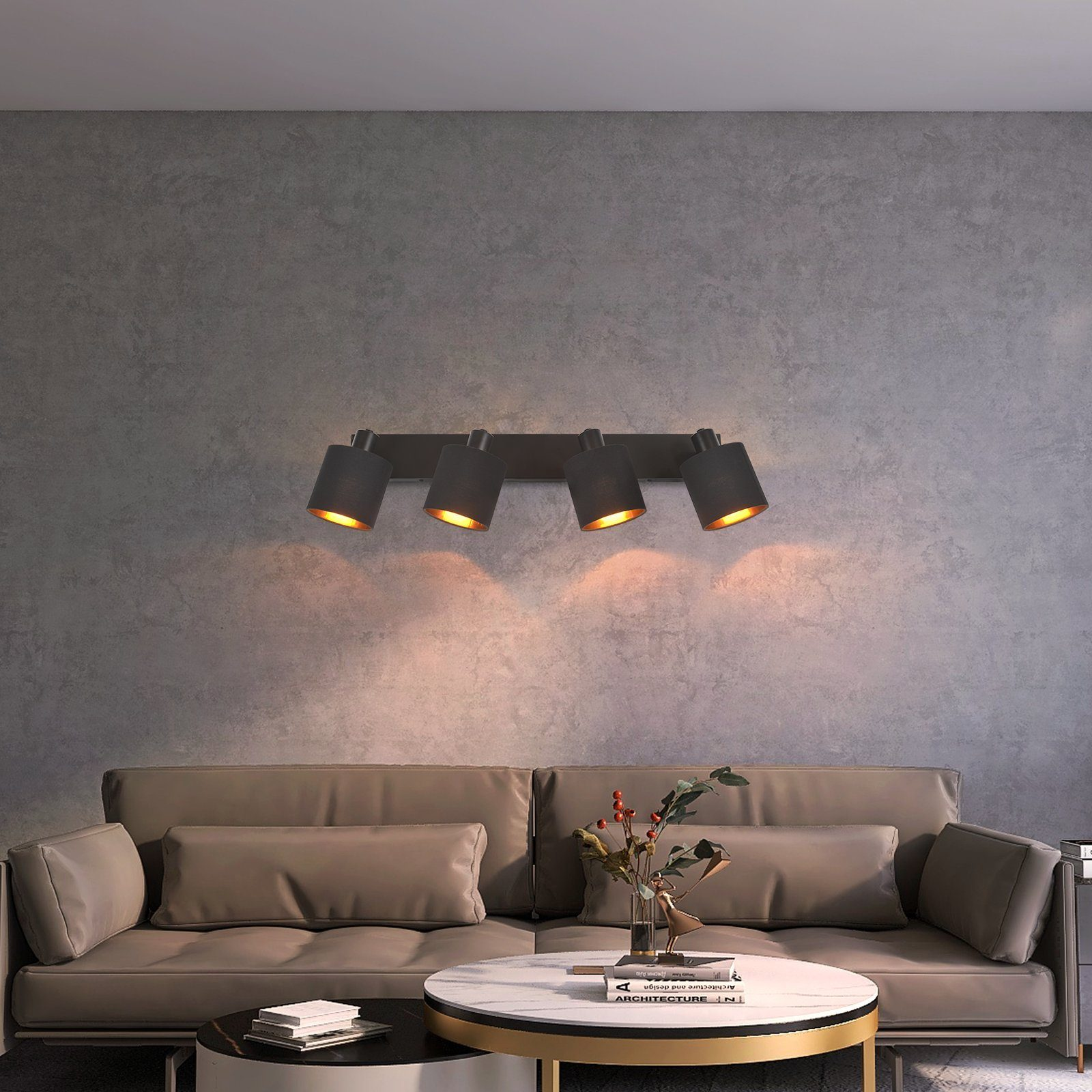 Soggiorno con illuminazione a parete moderna. Un divano e un tavolino in primo piano.