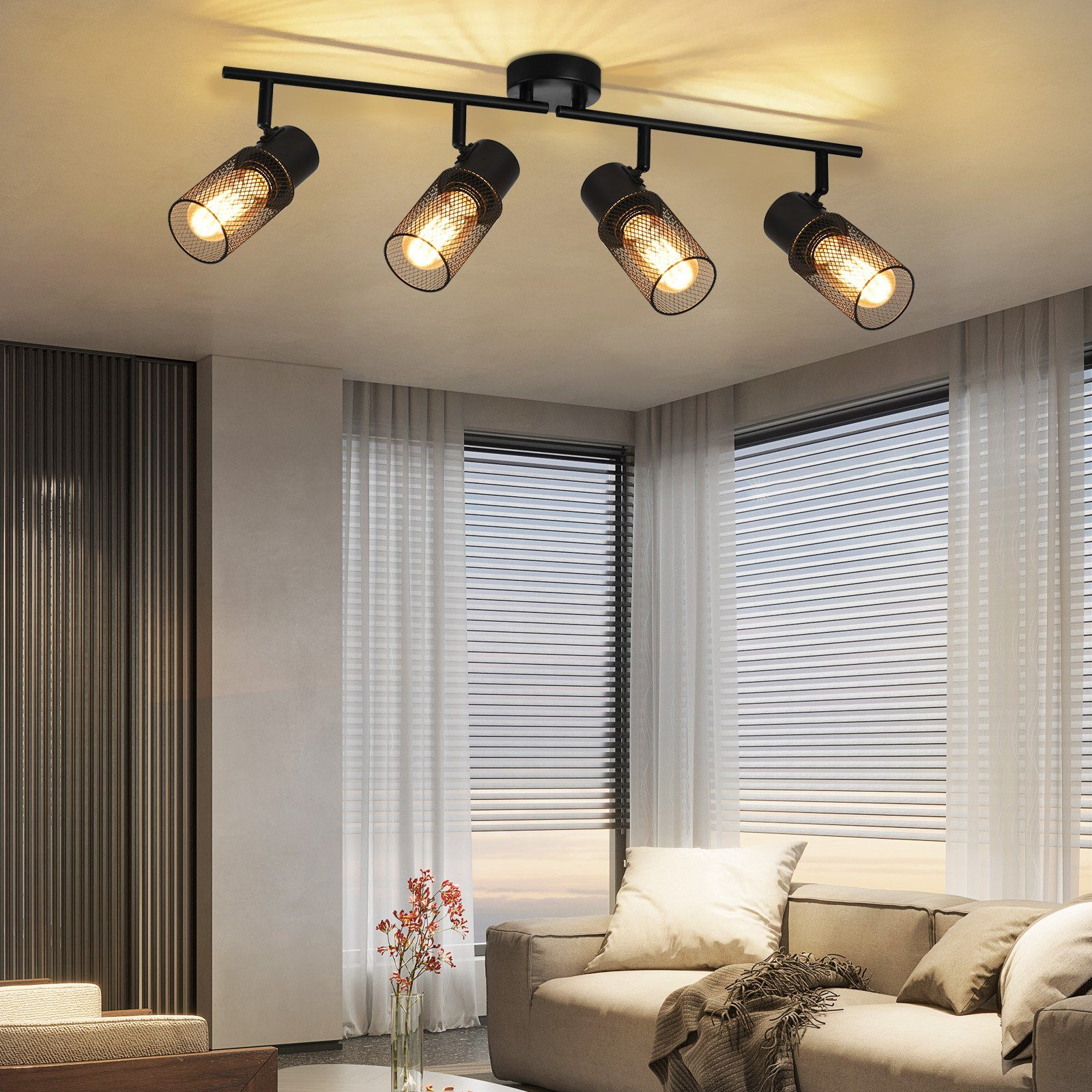 Czarna oprawa oświetleniowa szynowa z czterema regulowanymi reflektorami na białym suficie.