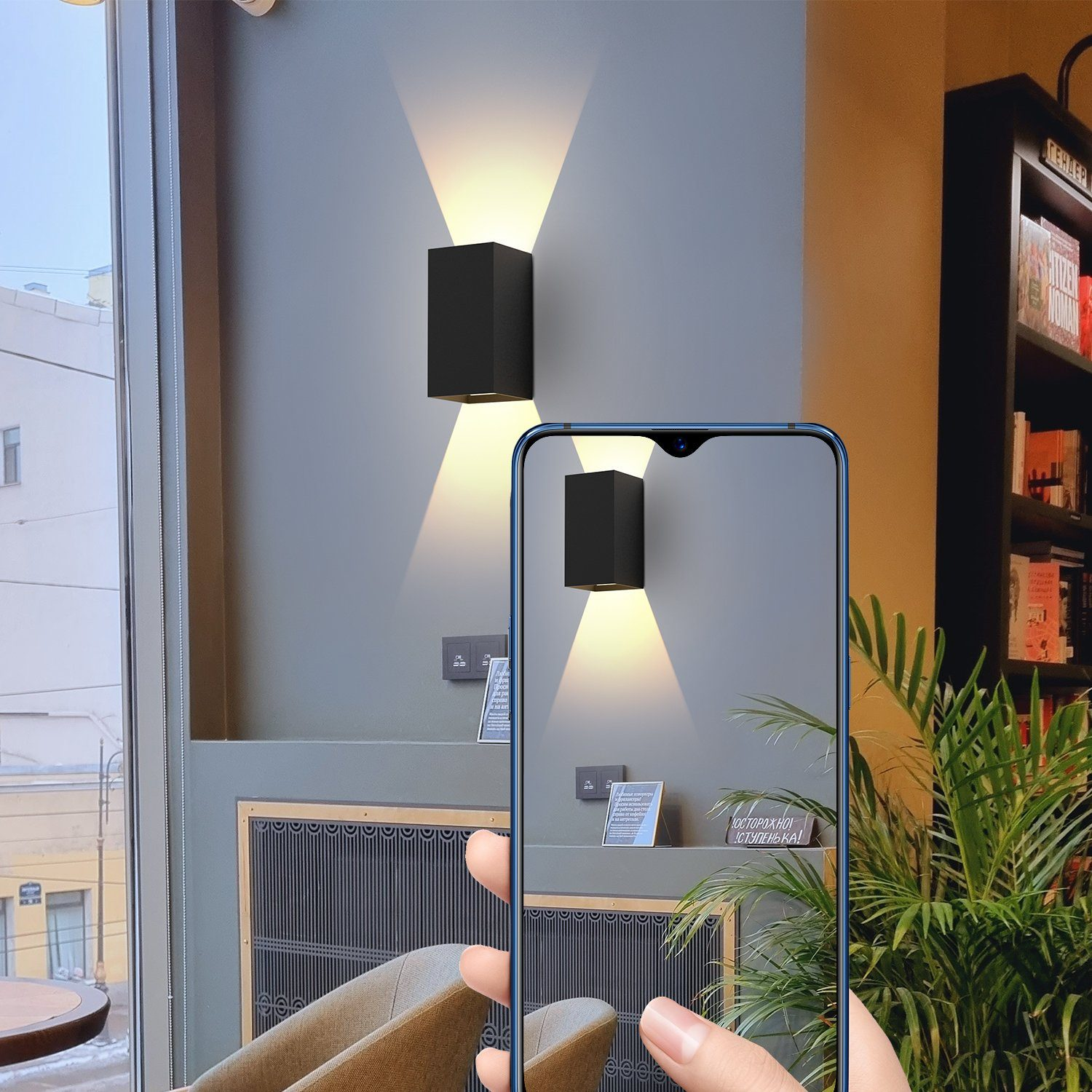 Telefon wyświetla ścianę z dwoma czarnymi światłami w kawiarni.