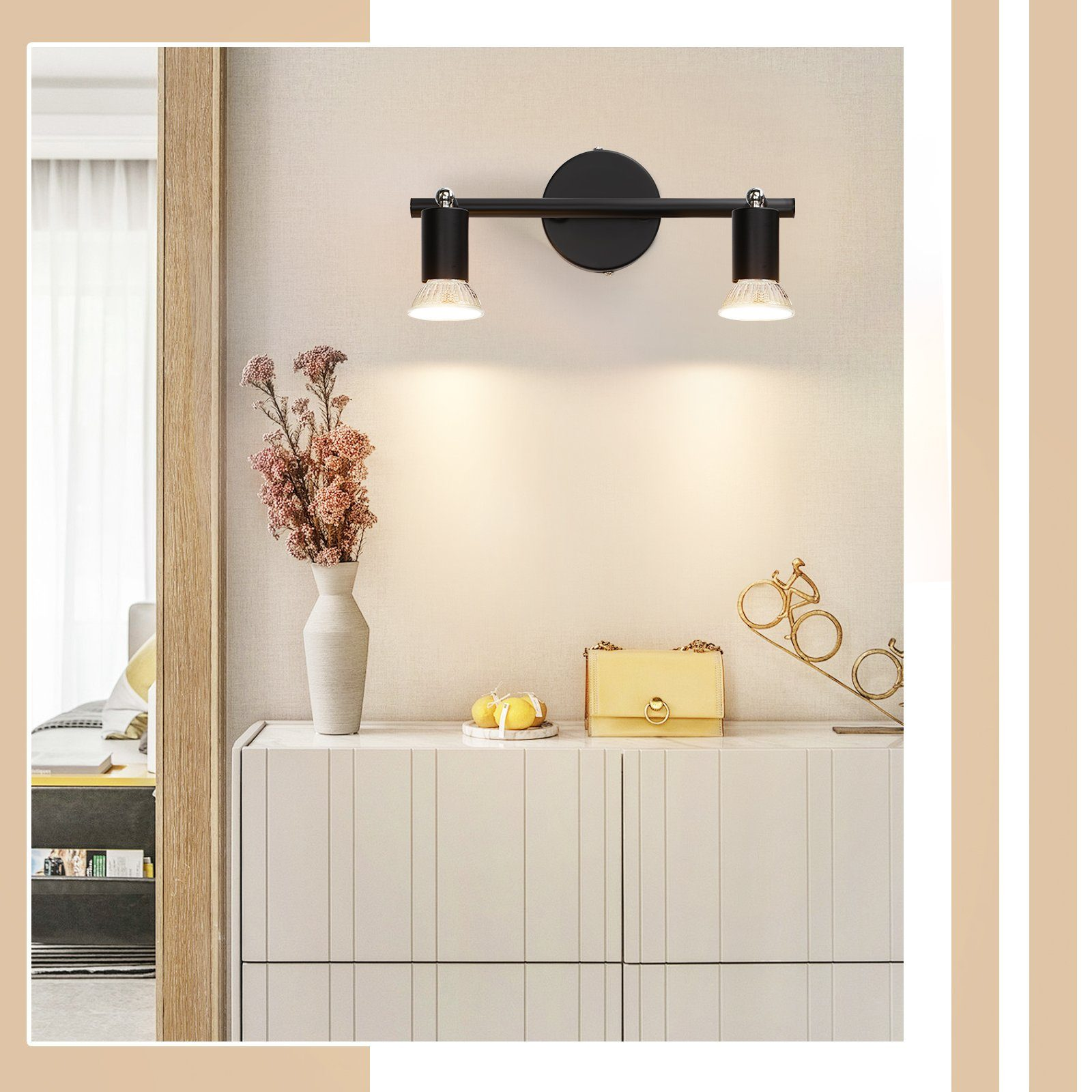 Nowoczesna biała szafka z elementami dekoracyjnymi i ścianą z dwoma reflektorami.