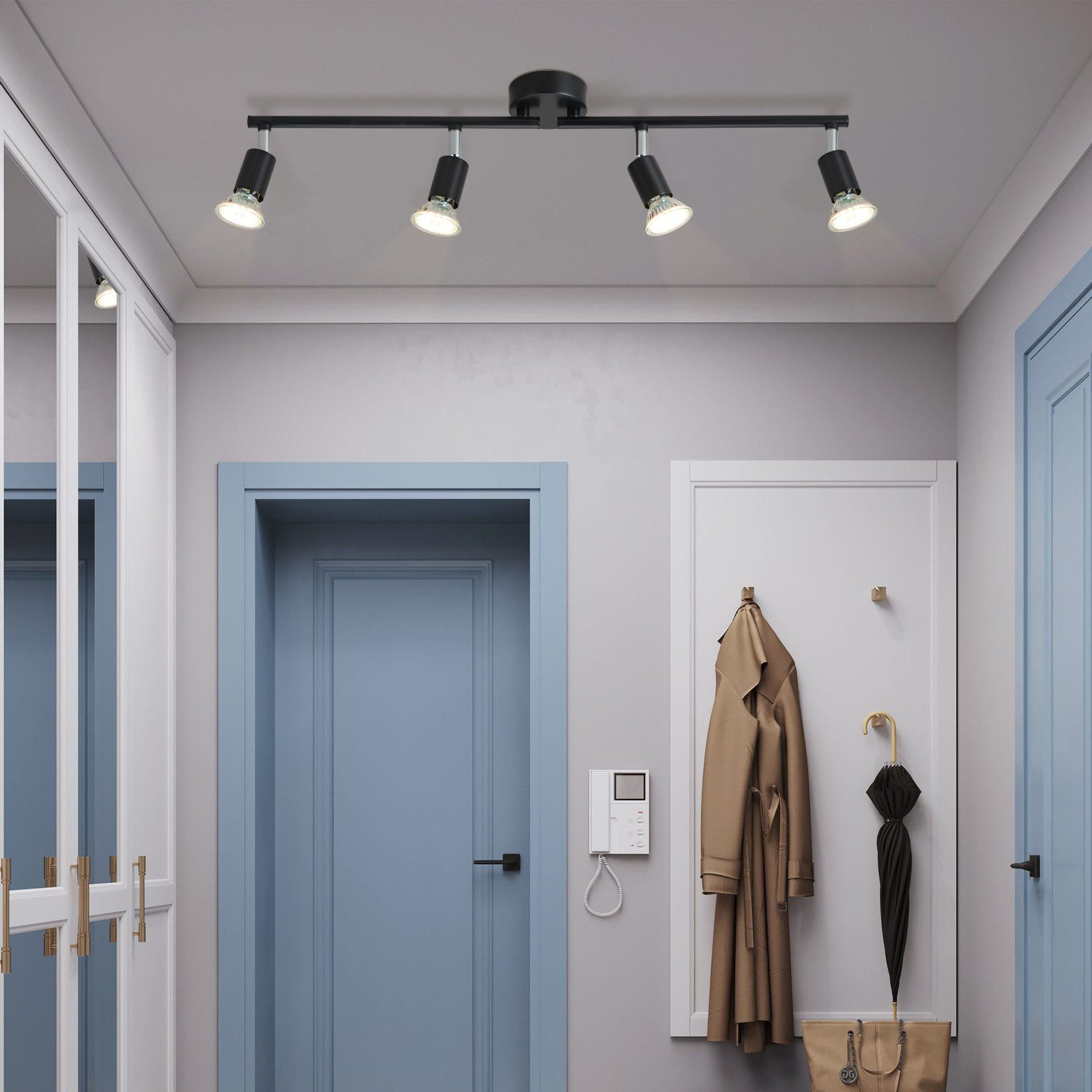 Korytarz z oprawą oświetleniową sufitową z czterema reflektorami. Drzwi i wieszak na ubrania w tle.