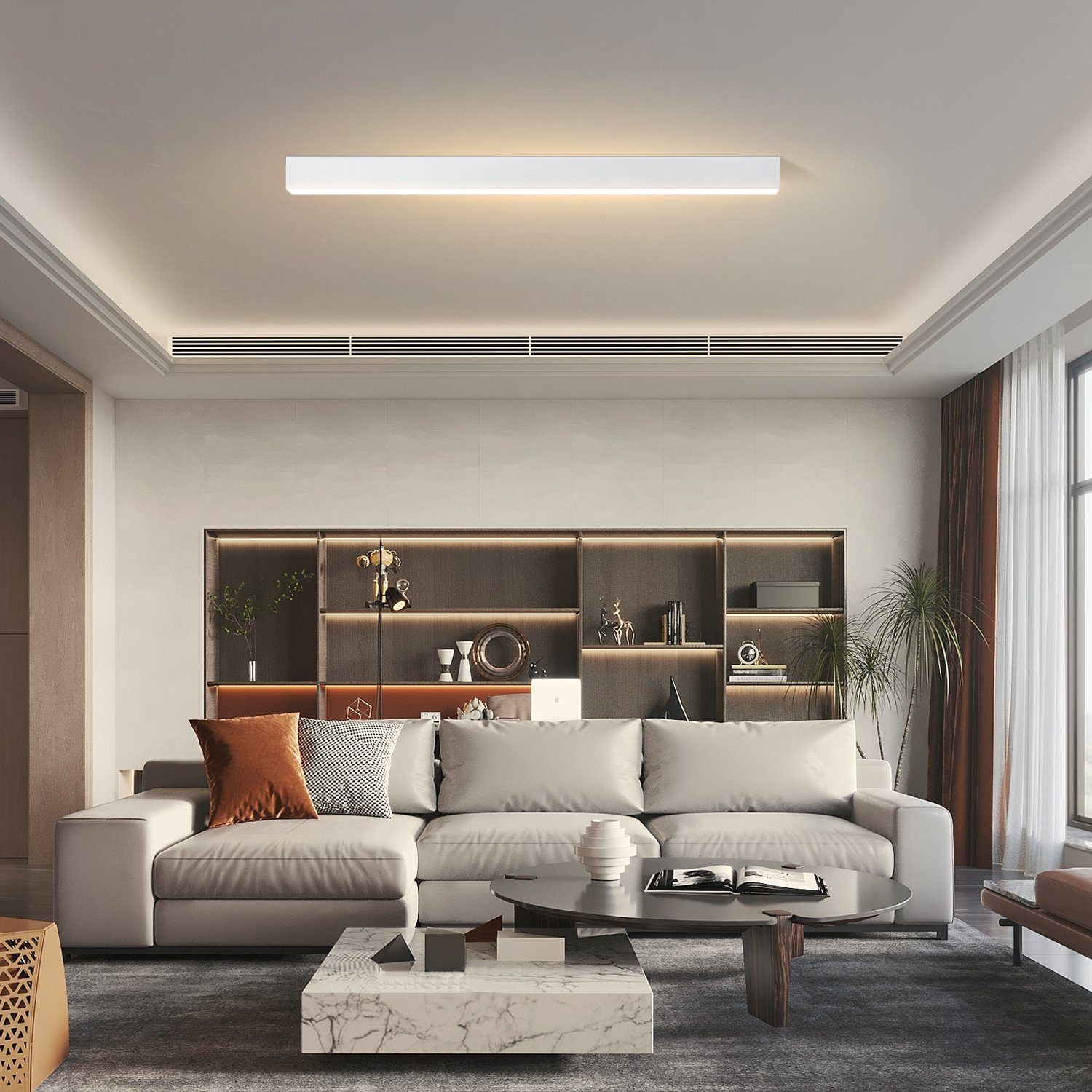 Nowoczesny salon z białą sofą, stolikiem kawowym i długą, białą lampą sufitową.