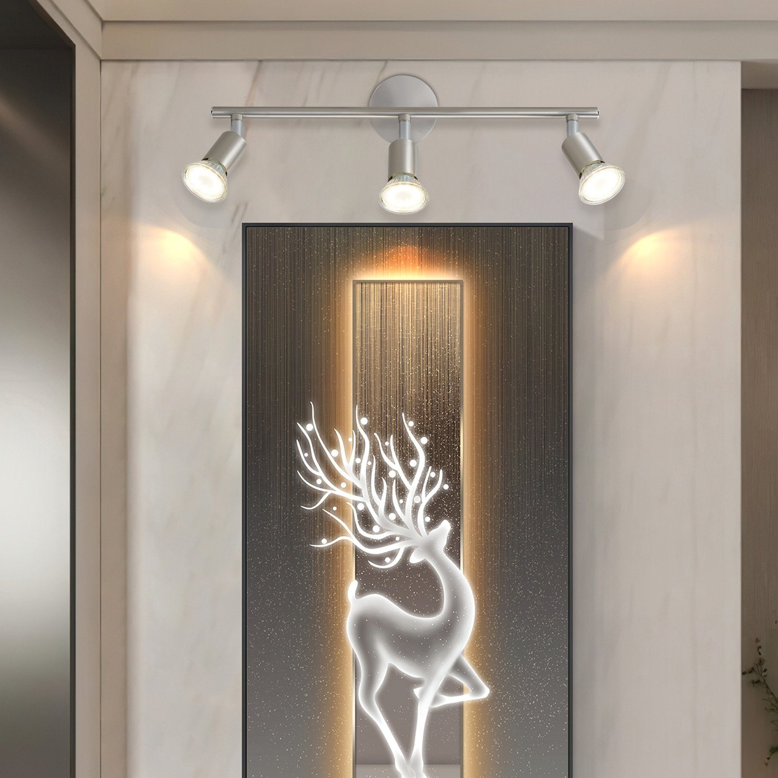 Trzy reflektory na ścianie z obrazem białego jelenia.