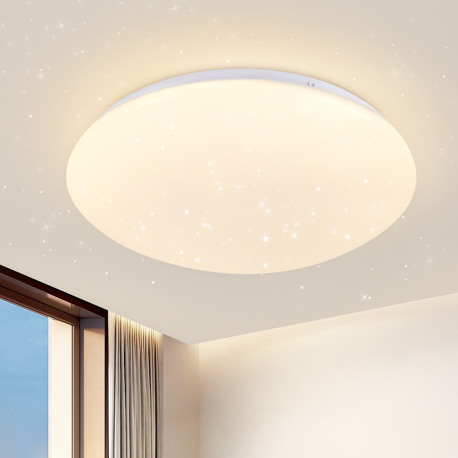 Lampada da soffitto rotonda con un centro luminoso e luci a forma di stella sparse.