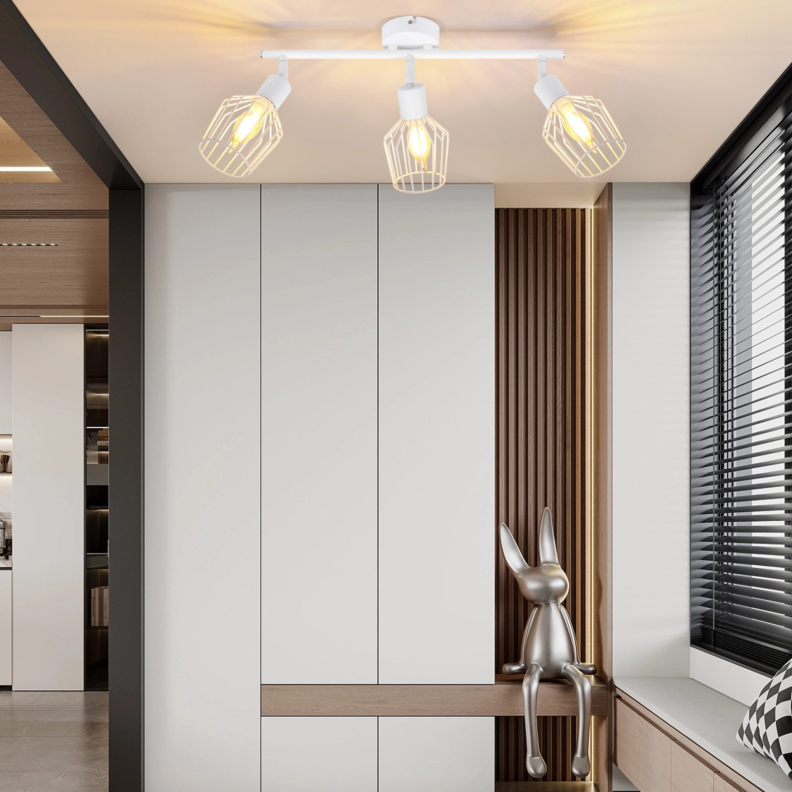 Białe lampy sufitowe z trzema regulowanymi lampami, na tle neutralnego wnętrza.