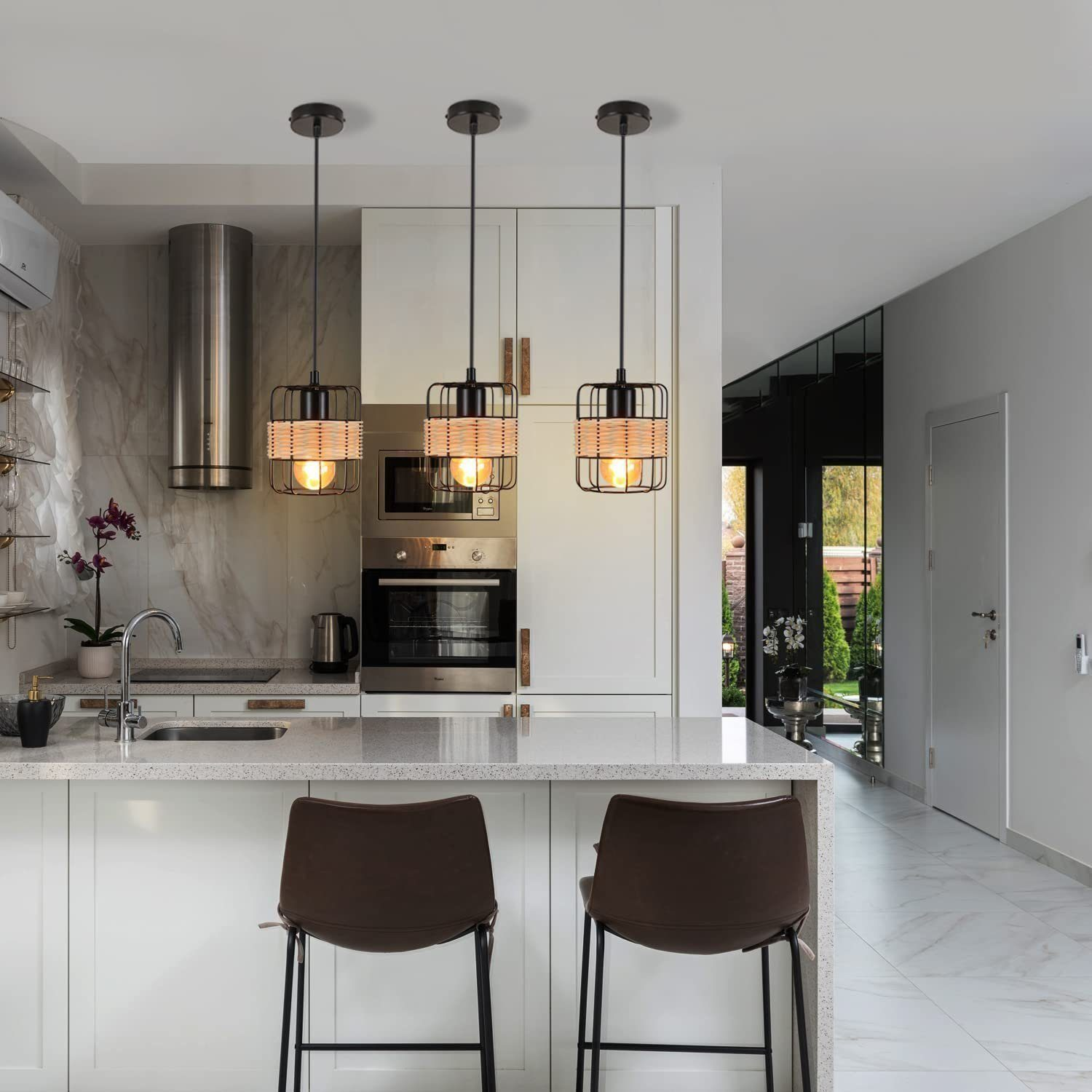 Kuchnia z trzema lampami wiszącymi nad wyspą. Nowoczesny design z czarnymi akcentami.